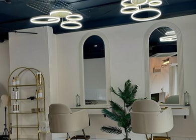 Modern beauty salon interior at Lewa Studios, Birmingham, England, GB, featuring elegant seating and lighting.