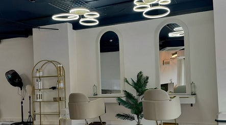 Modern beauty salon interior at Lewa Studios, Birmingham, England, GB, featuring elegant seating and lighting.
