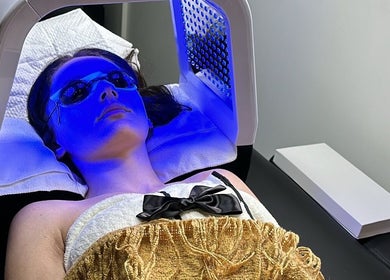 A client enjoys a blue light therapy session at Dermal glowz in Punchbowl, New South Wales, AU.