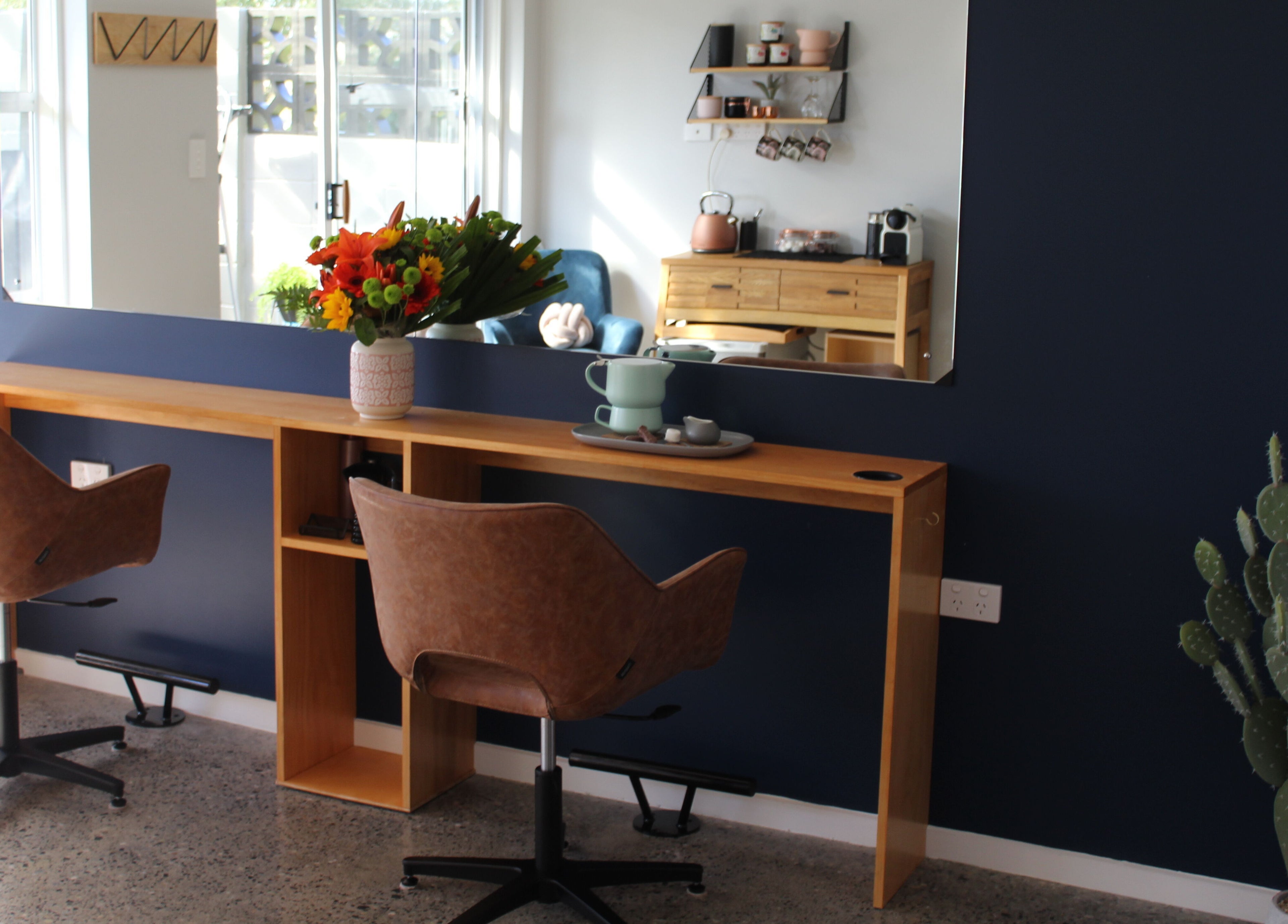 Elegant beauty salon interior at The Ginger Fox, Morrinsville, Waikato, NZ with chic seating and floral decor.