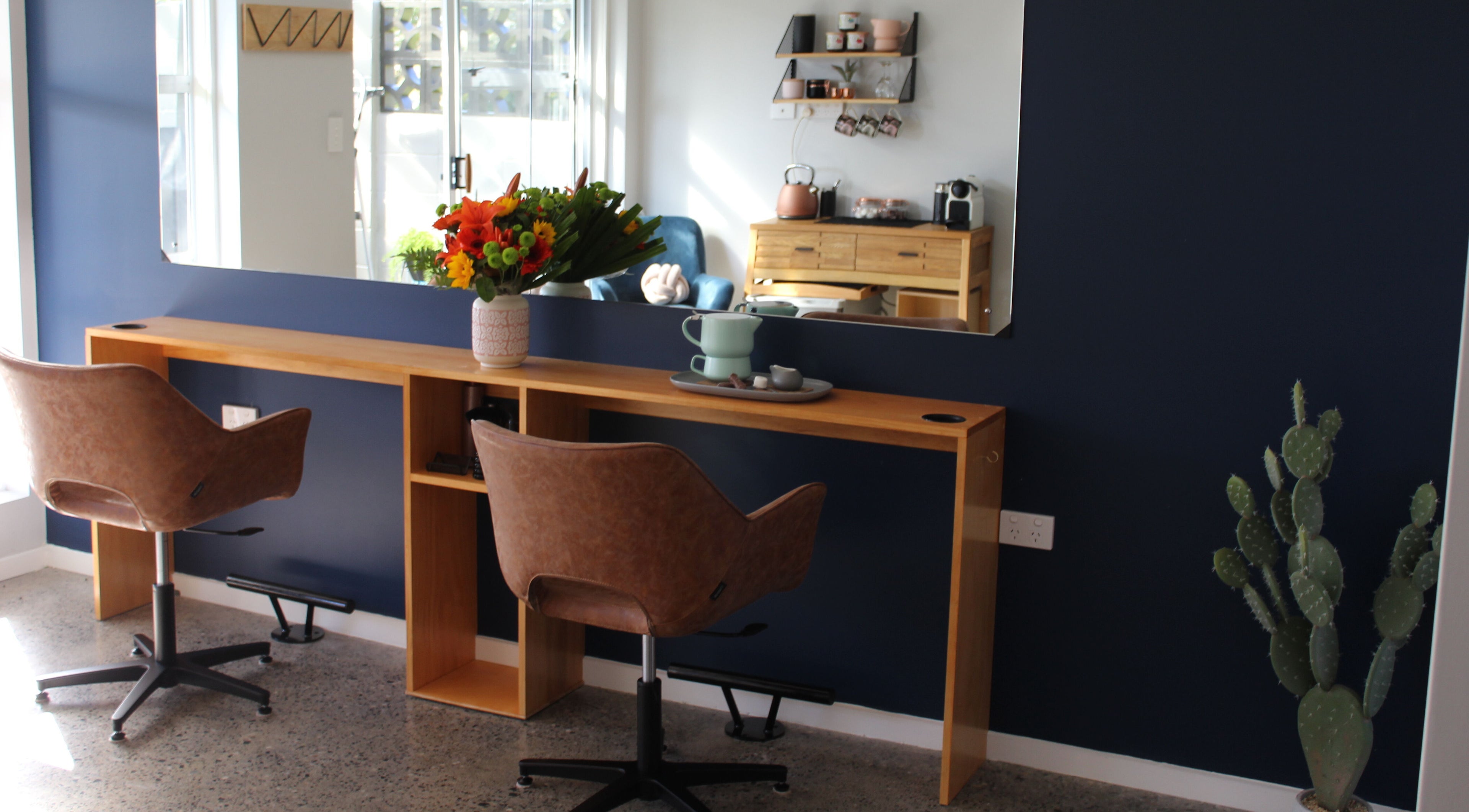 Elegant beauty salon interior at The Ginger Fox, Morrinsville, Waikato, NZ with chic seating and floral decor.