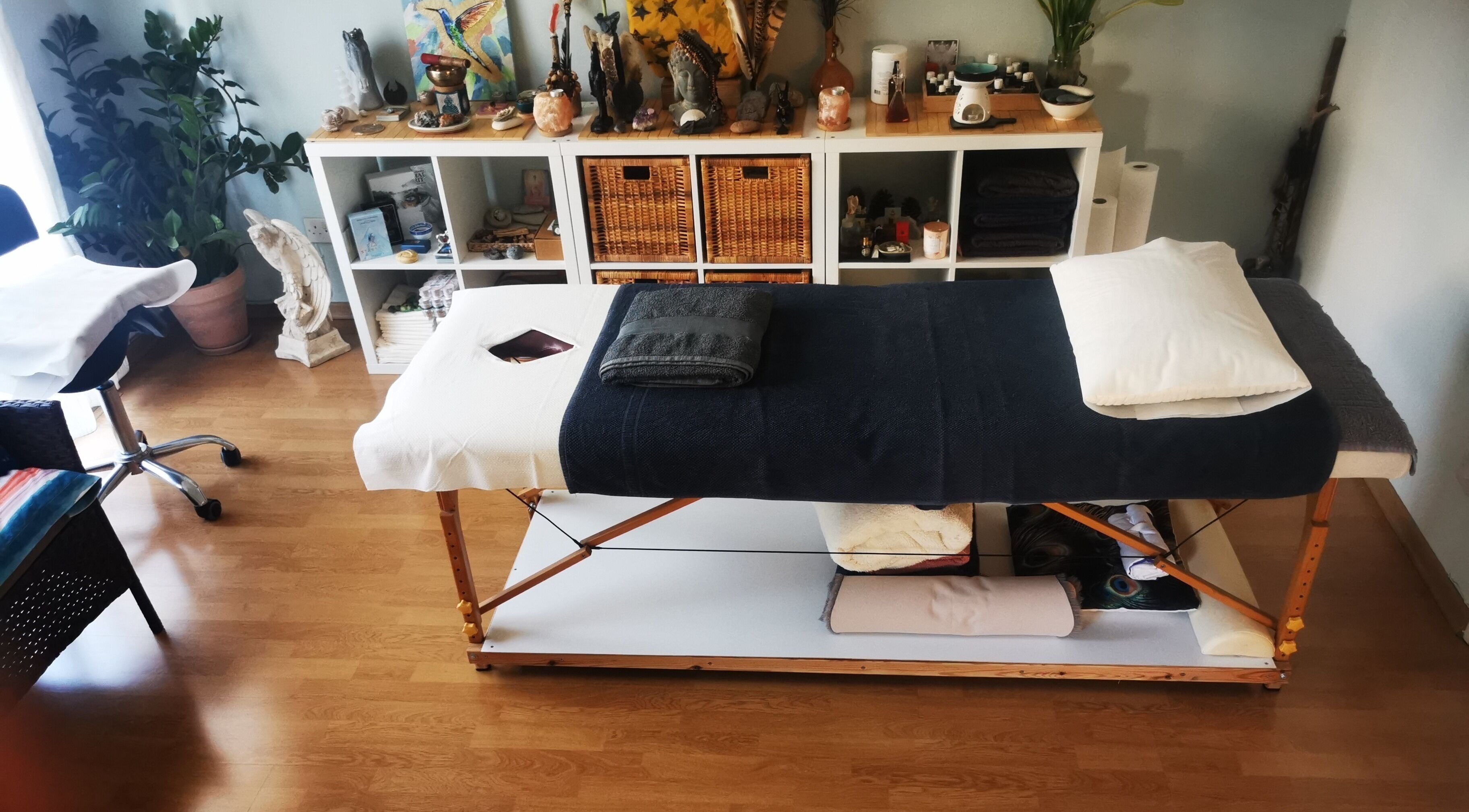 Massage room at Holistic Fingertips in Nicosia, CY, featuring a wooden massage table and calming decor.