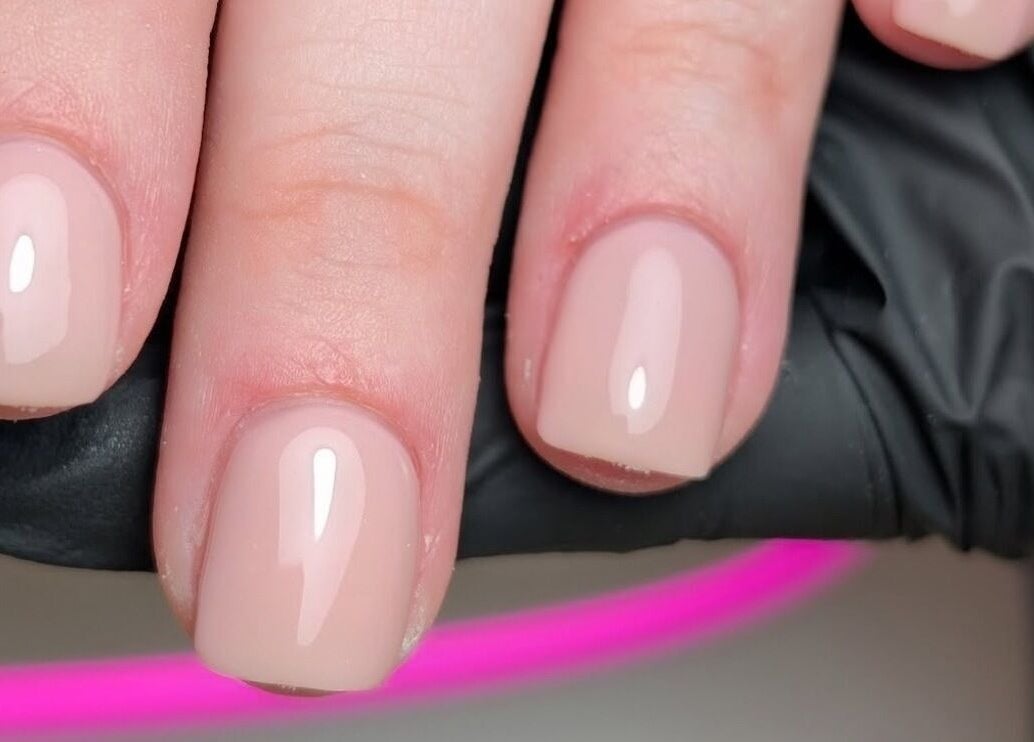 Close-up of perfectly manicured nails at CXM Nails in Bangor, Northern Ireland, GB showcasing glossy finish.