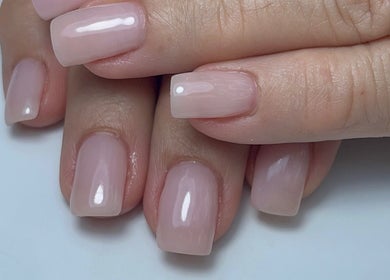Glossy pink nails by Xio’S Nails in Greensboro, North Carolina, US, showcasing expert nail care.