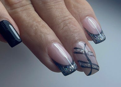 Stylish black and glitter nails crafted at Xio's Nails, Greensboro, North Carolina, US.