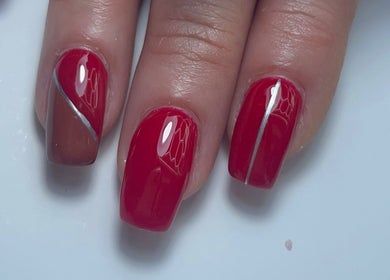 Stylish red nails with sleek designs at Xio’s Nails, Greensboro, North Carolina, US.