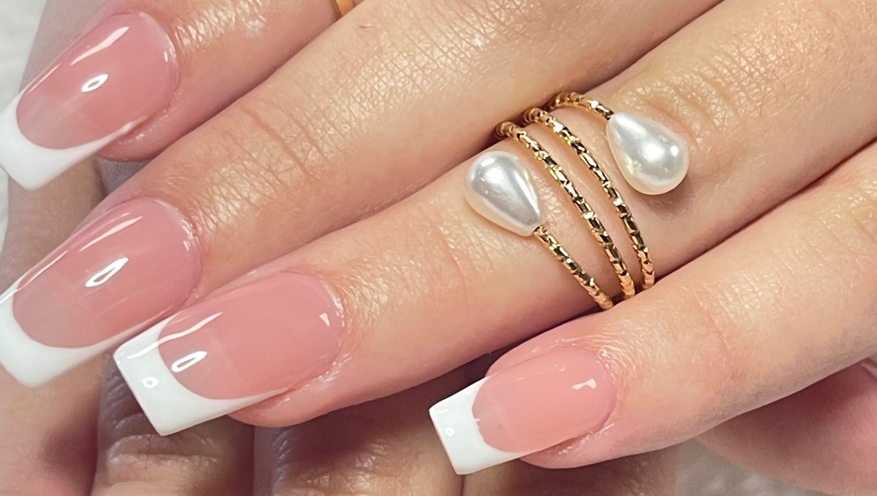 French manicure with pearl ring at Xio'S Nails, Greensboro, North Carolina, US.