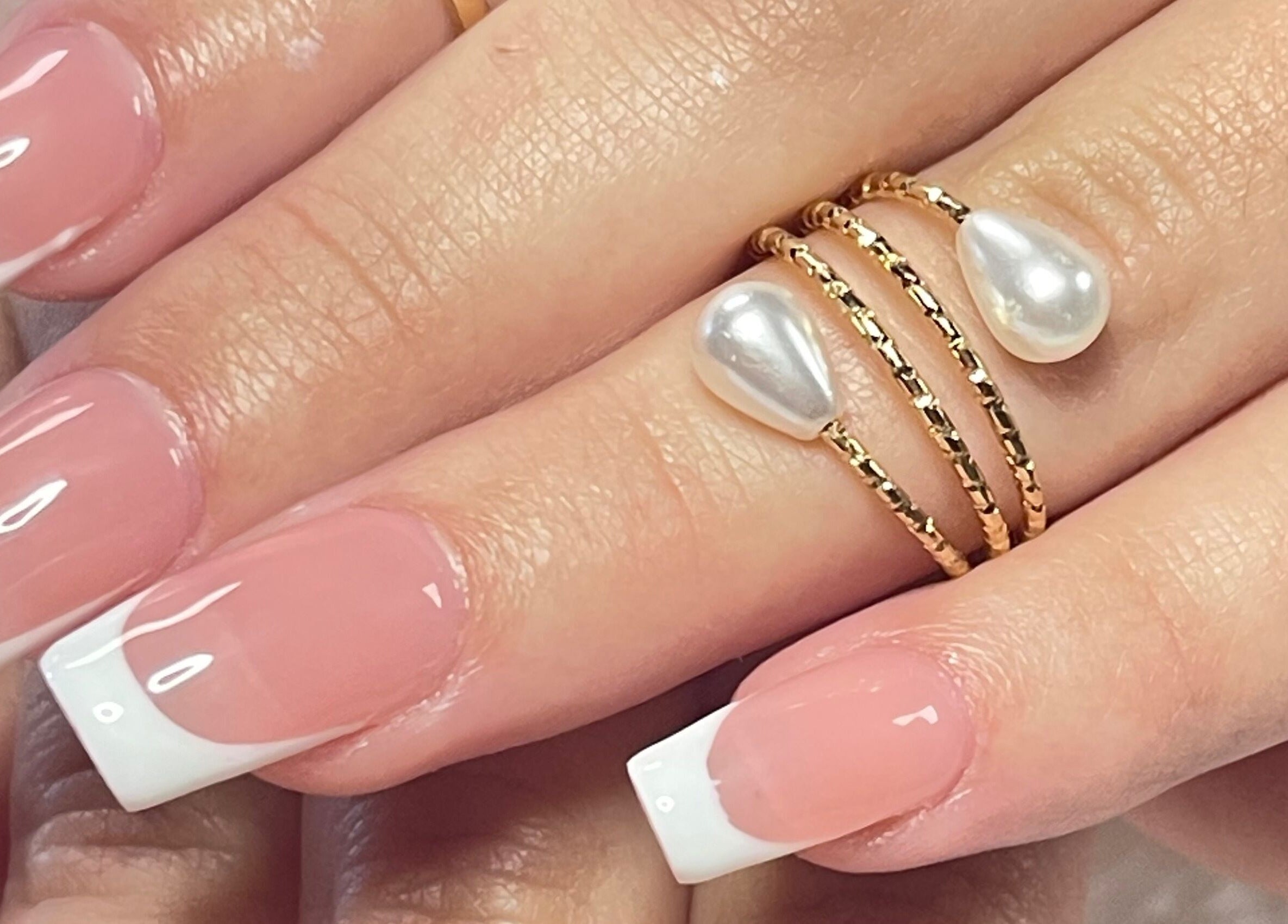French manicure with pearl ring at Xio'S Nails, Greensboro, North Carolina, US.