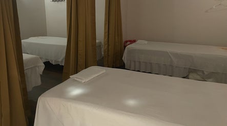 Relaxing massage beds with curtains at Ancient Thai Massage, Los Angeles, California, US.