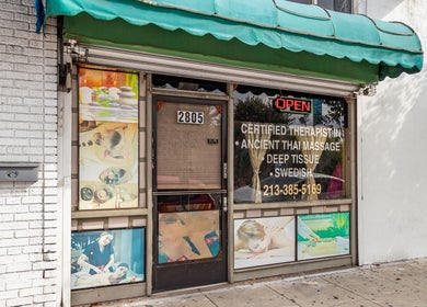 Front entrance of Ancient Thai Massage in Los Angeles, California, US with massage options displayed.