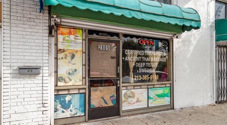 Front entrance of Ancient Thai Massage in Los Angeles, California, US with massage options displayed.