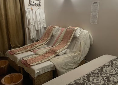Cozy massage room at Ancient Thai Massage in Los Angeles, California, US with plush chairs and robes.