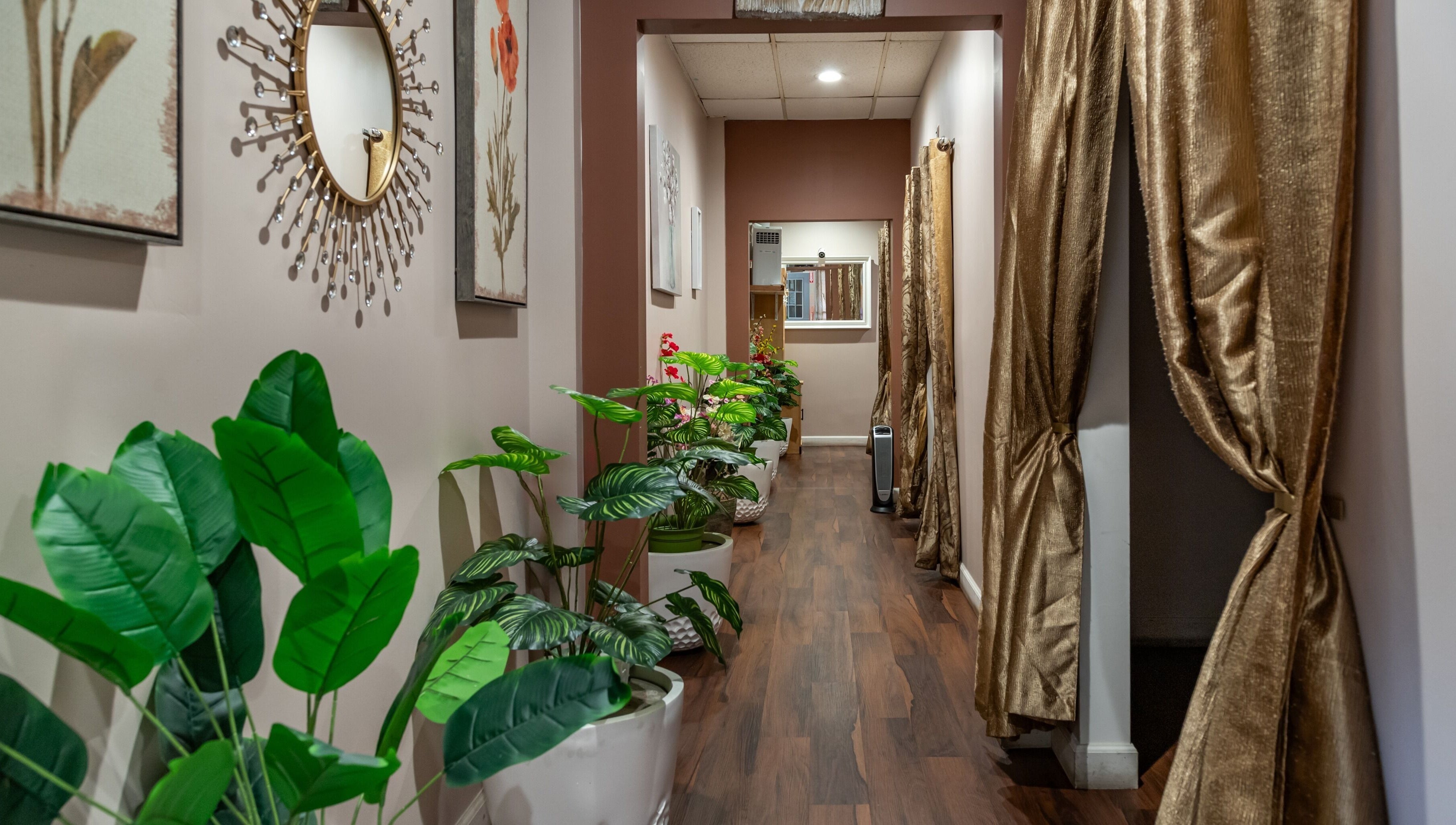 Elegant corridor of Ancient Thai Massage in Los Angeles, California, US with lush plants and serene decor.