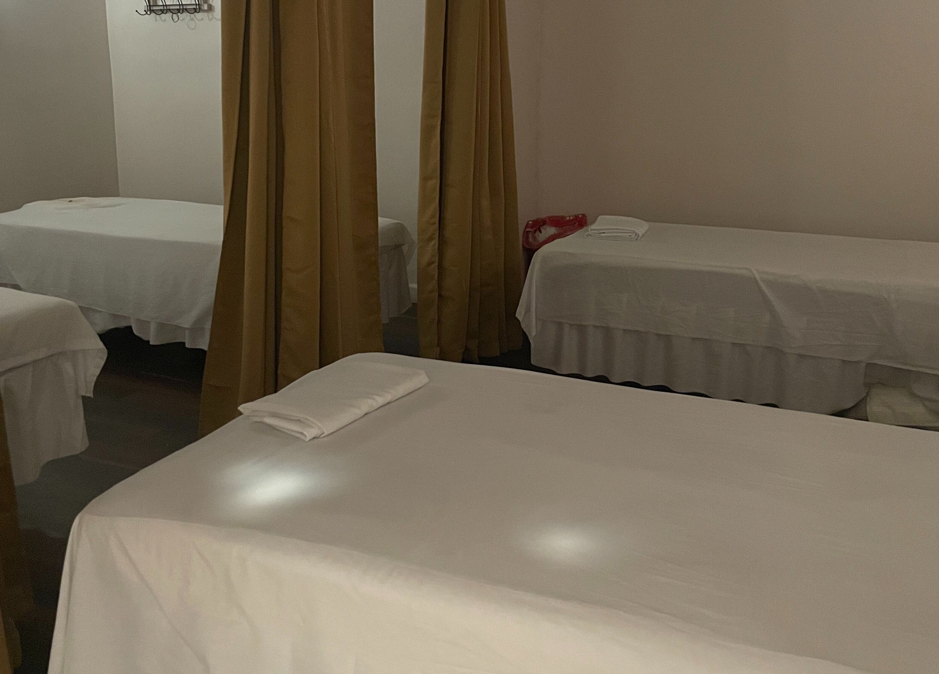 Cozy massage beds with curtains at Ancient Thai Massage, Los Angeles, California, US.