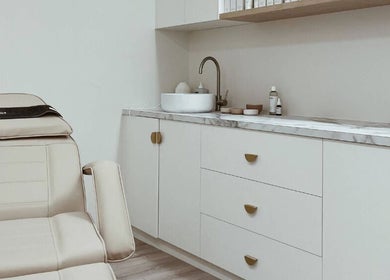 Luxury treatment room at Elesay, Mackay, Queensland, AU featuring a comfortable chair and modern sink area.