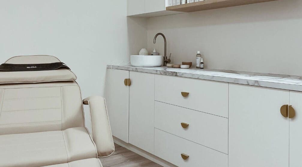 Luxury treatment room at Elesay, Mackay, Queensland, AU featuring a comfortable chair and modern sink area.