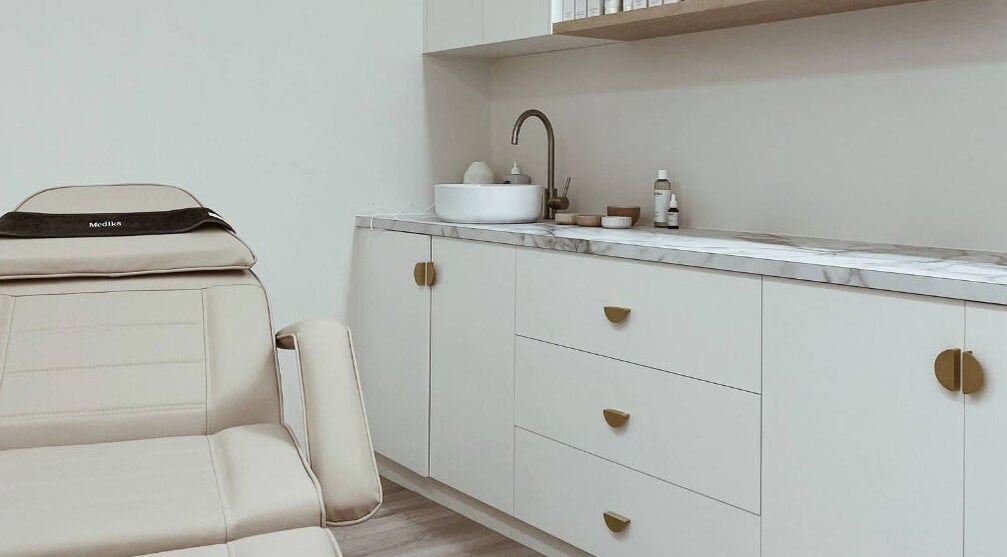 Luxury treatment room at Elesay, Mackay, Queensland, AU featuring a comfortable chair and modern sink area.