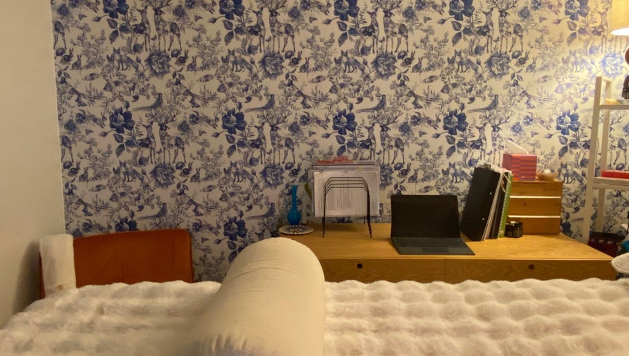 Inviting room at Larose Kinesiology, West End, Queensland, AU with blue floral wallpaper and cozy furnishings.