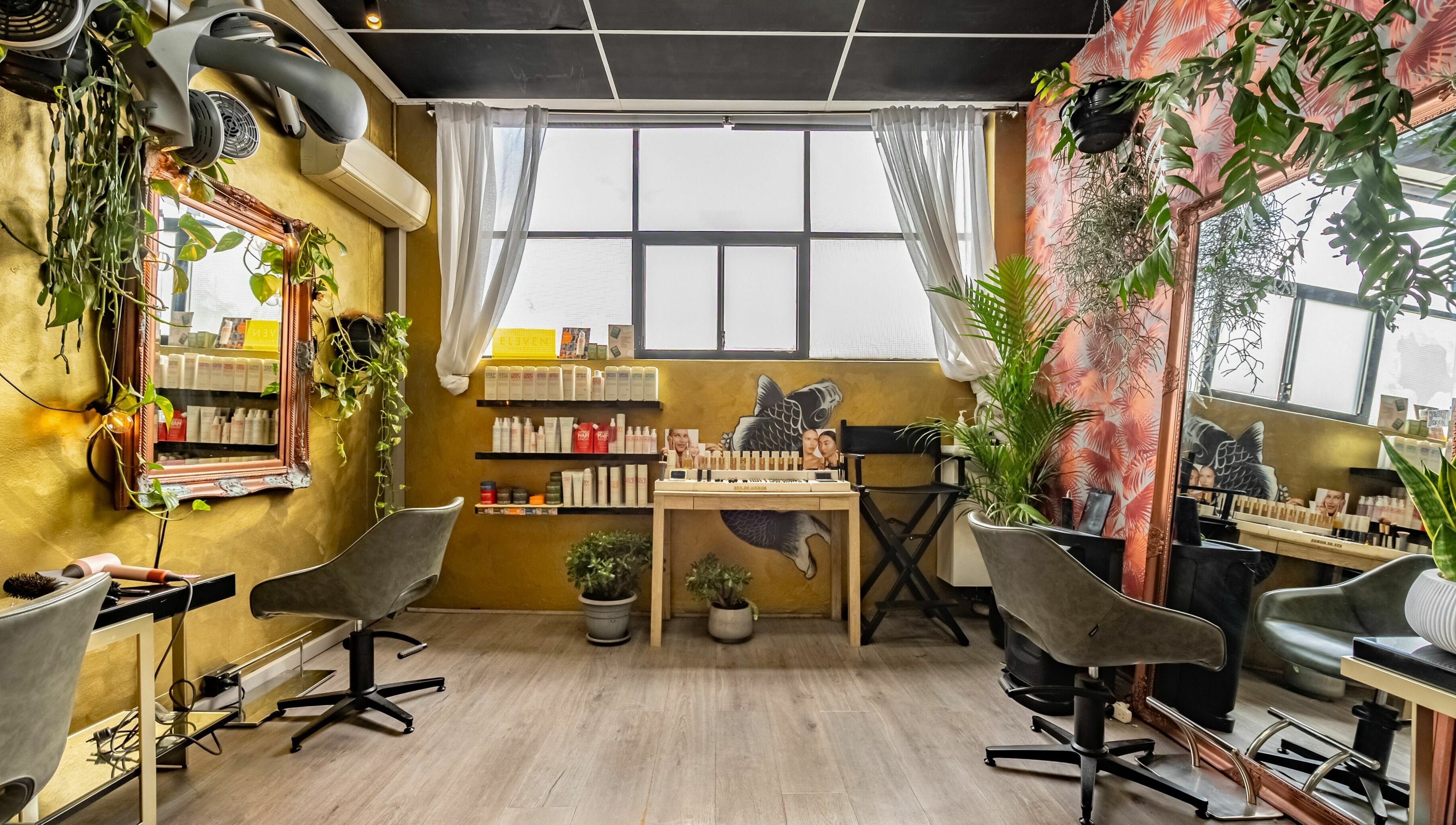 Public Hair Studio's chic interior with styling stations and vibrant decor in Brookvale, NSW, AU.