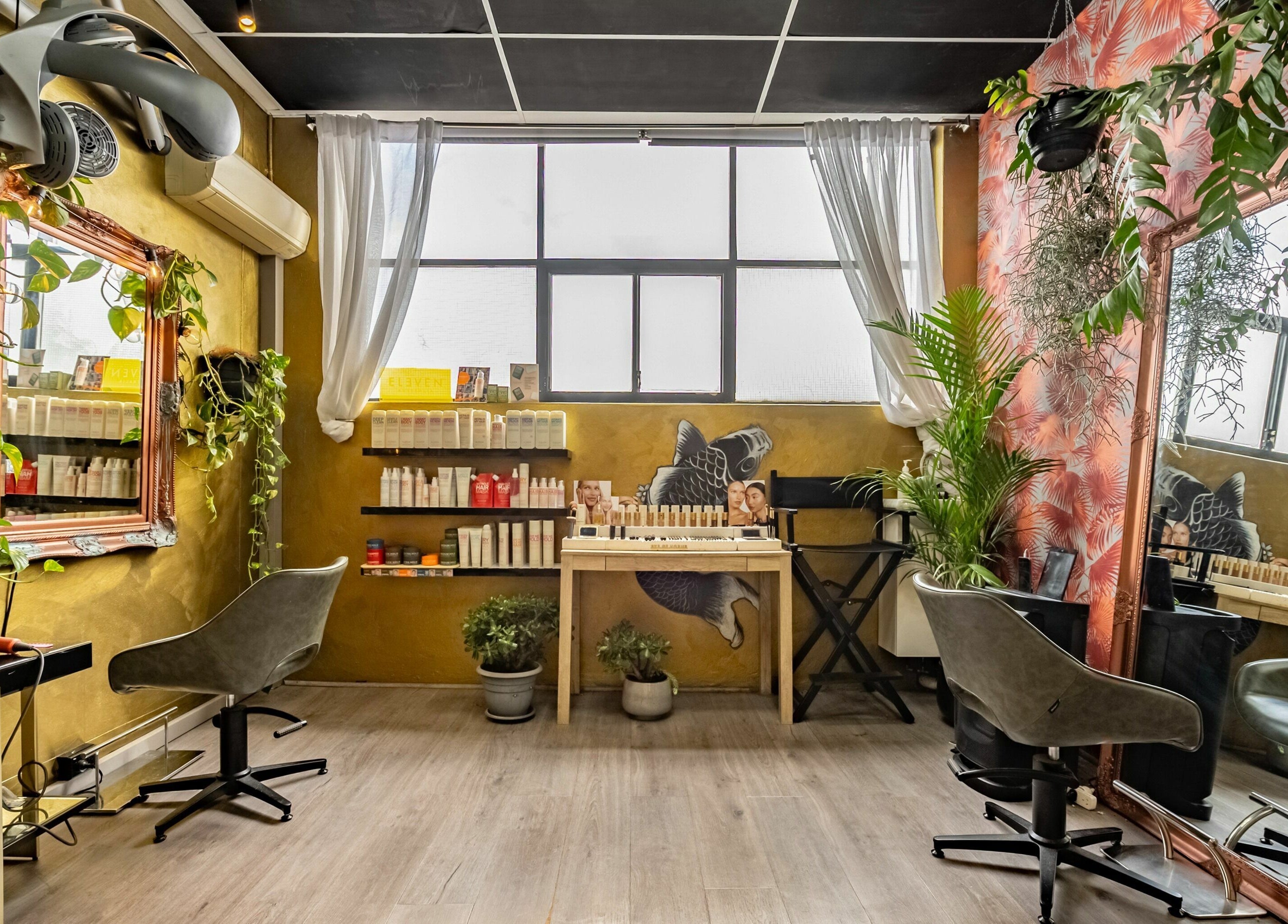 Public Hair Studio's chic interior with styling stations and vibrant decor in Brookvale, NSW, AU.