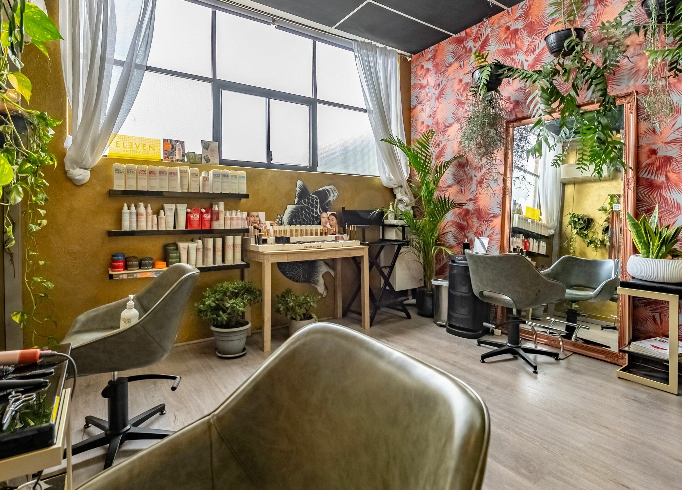 Interior of Public Hair Studio in Brookvale, NSW, AU featuring lush plants and stylish decor.
