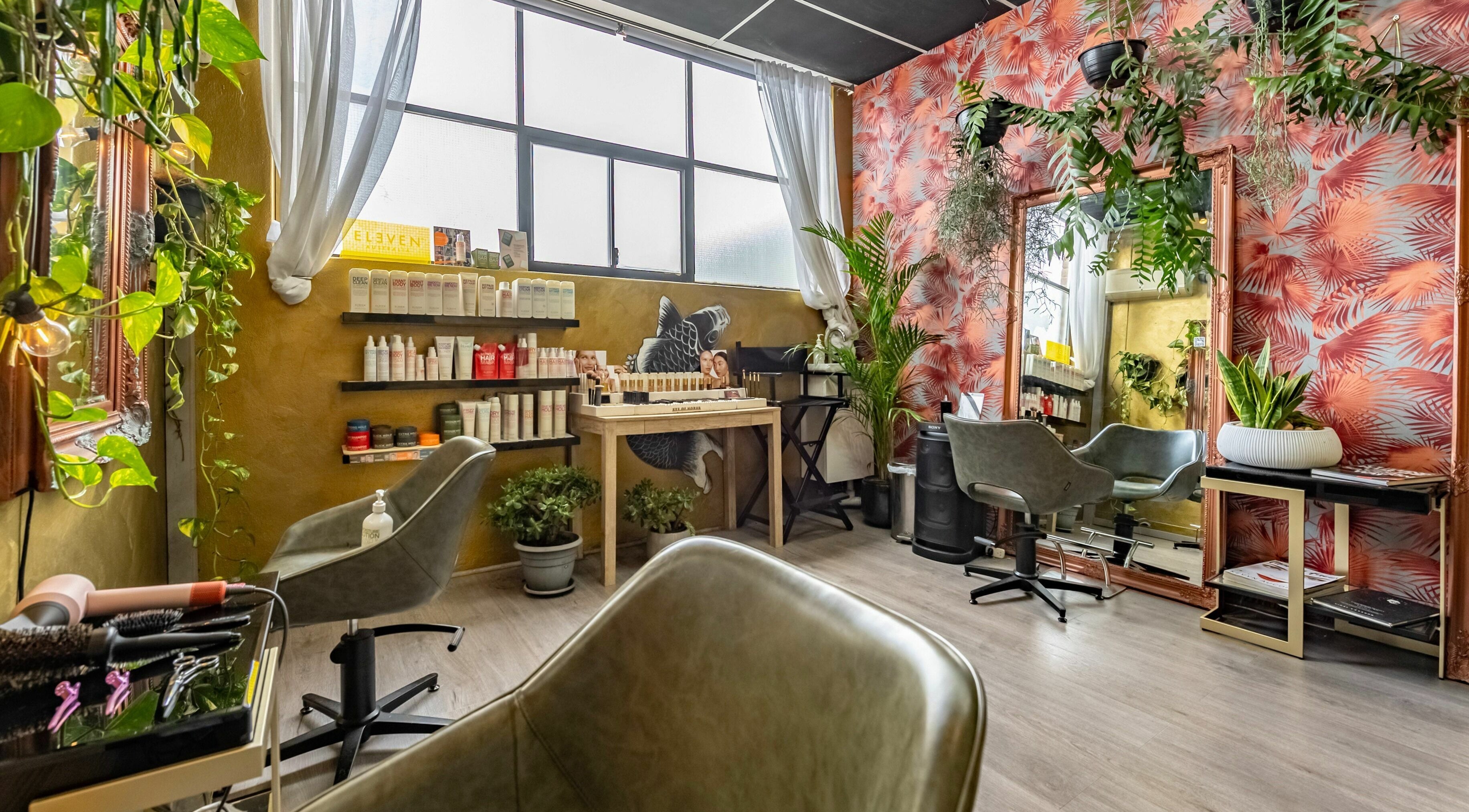 Interior of Public Hair Studio in Brookvale, NSW, AU featuring lush plants and stylish decor.
