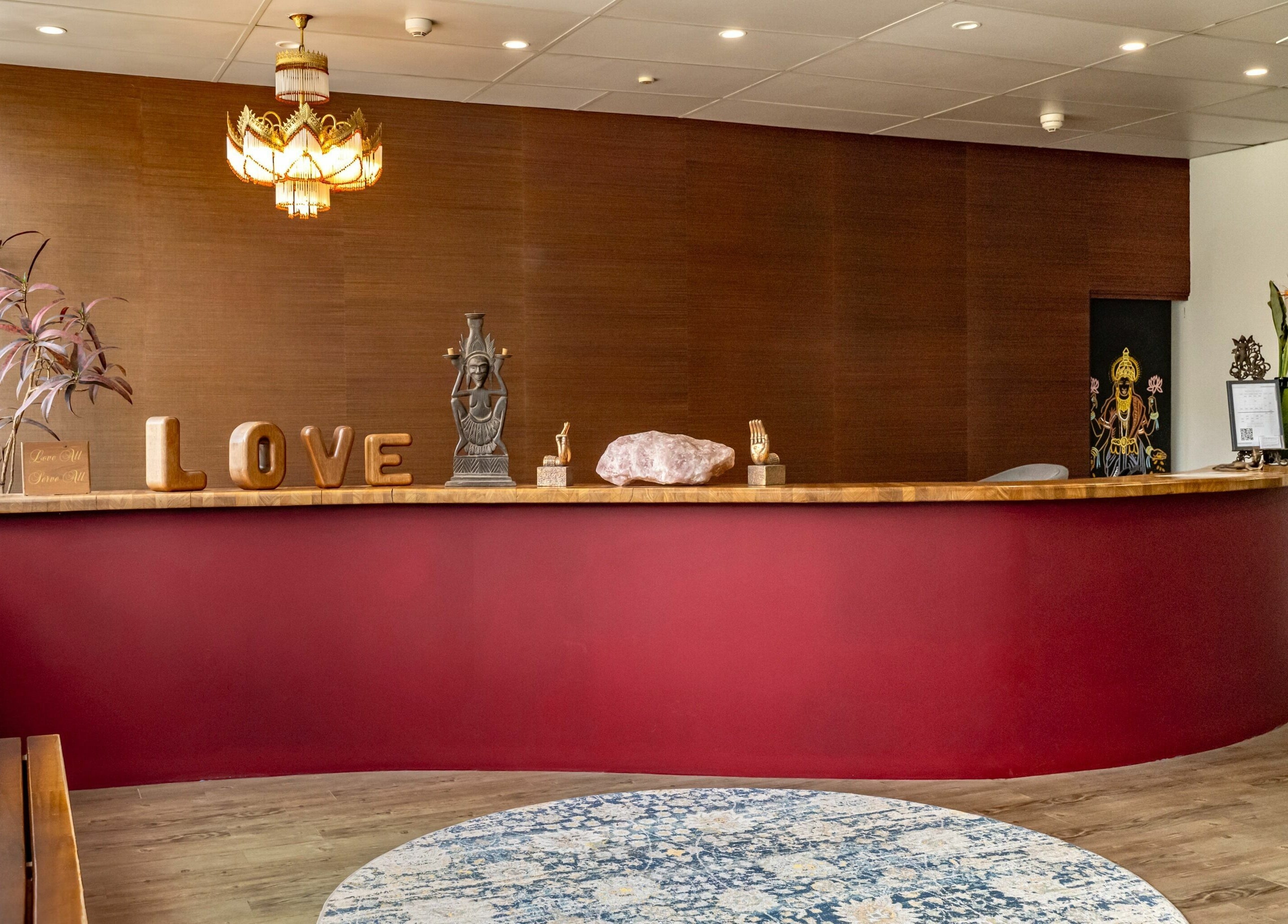 Welcoming reception at Public Hair Studio, Brookvale, NSW, AU with a red desk and elegant decor.