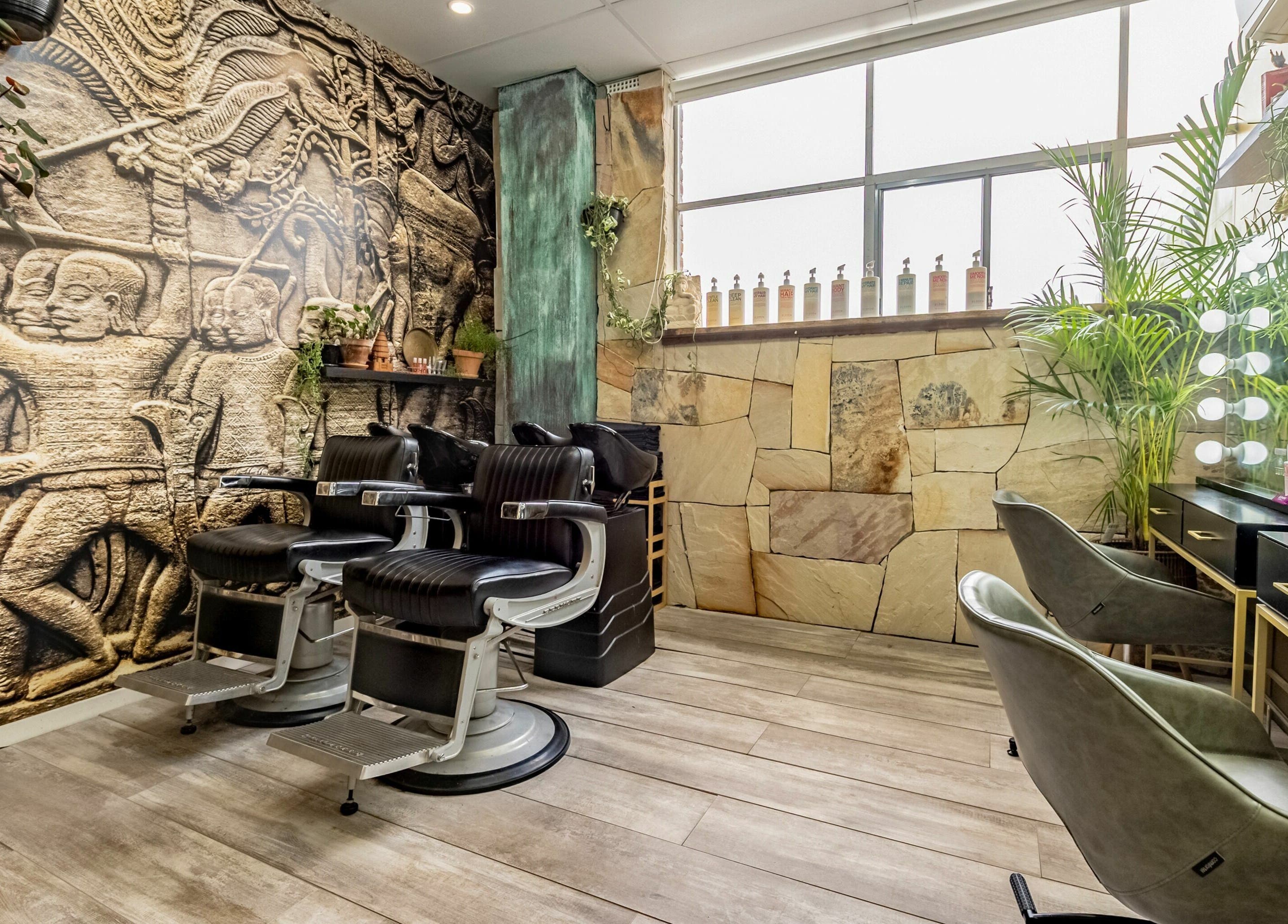Stylish seating and ornate mural at Public Hair Studio, Brookvale, NSW, AU showcasing modern and artistic decor.