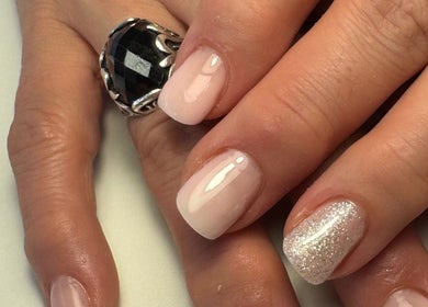 Elegant manicured nails with glitter polish at JMCnailsalon, Yeovil, England, GB.