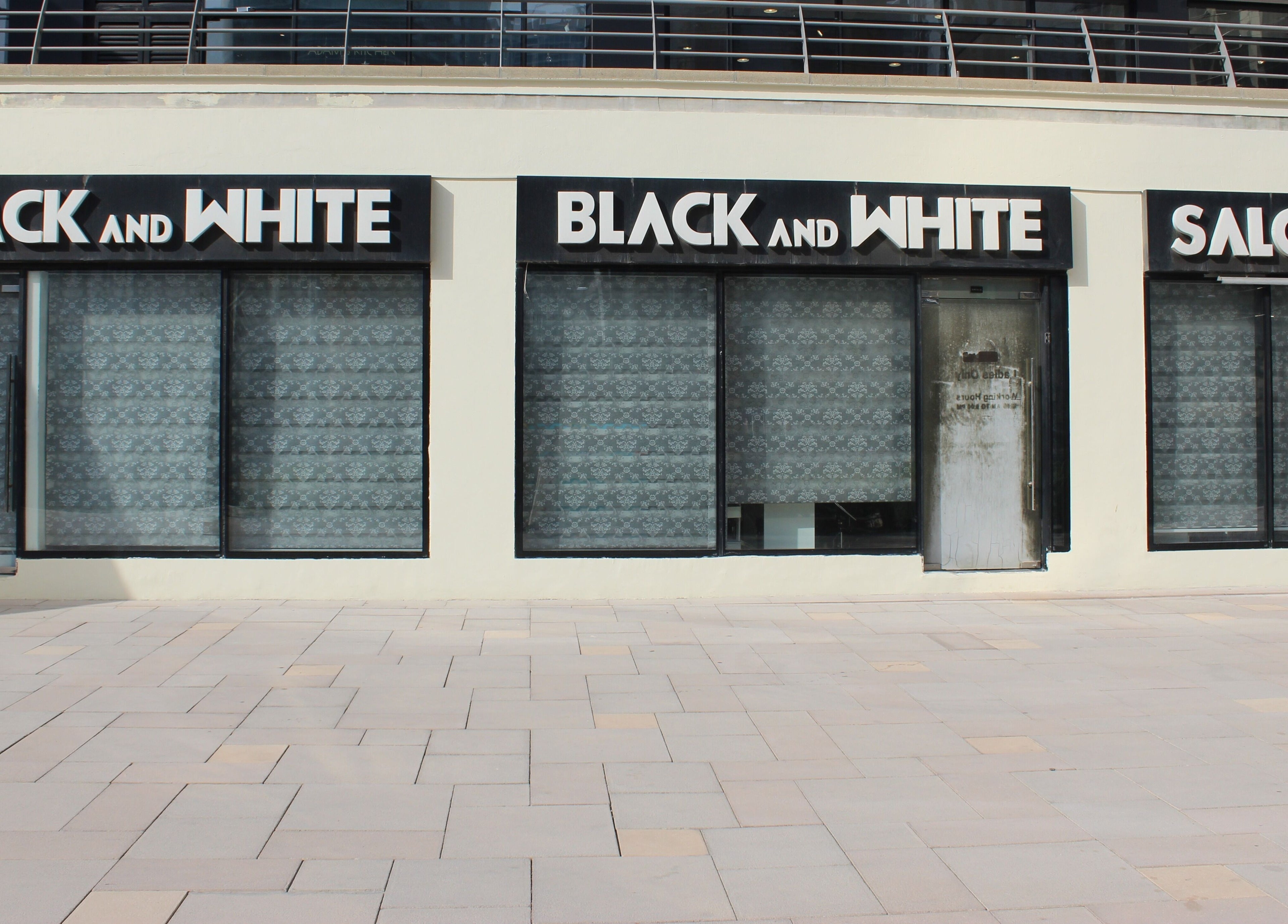 Exterior of Black & White Salon in Dubai, Dubai, AE featuring modern design and chic signage.