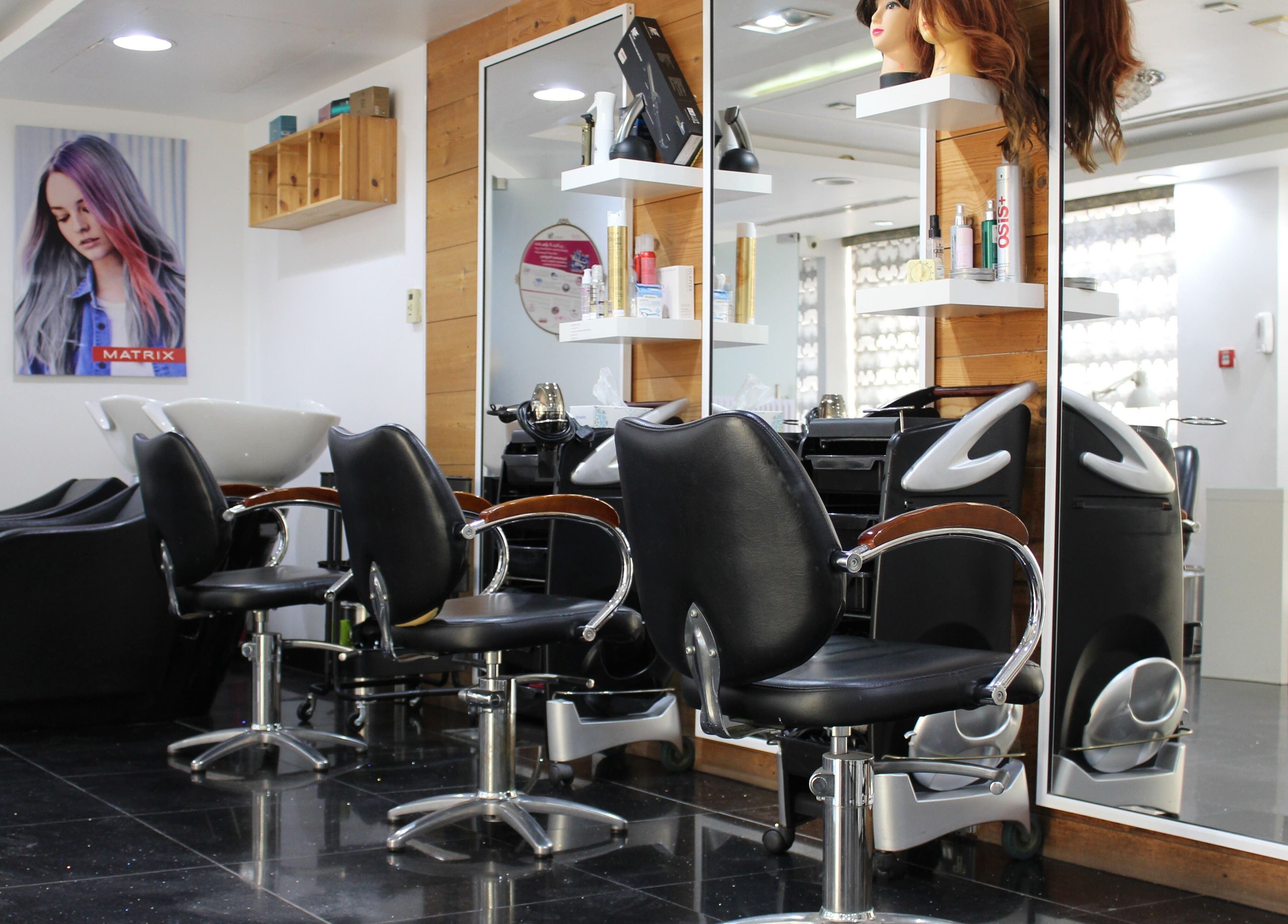 Modern styling chairs at Black & White Salon, Dubai, Dubai, AE, showcasing sleek interior design.