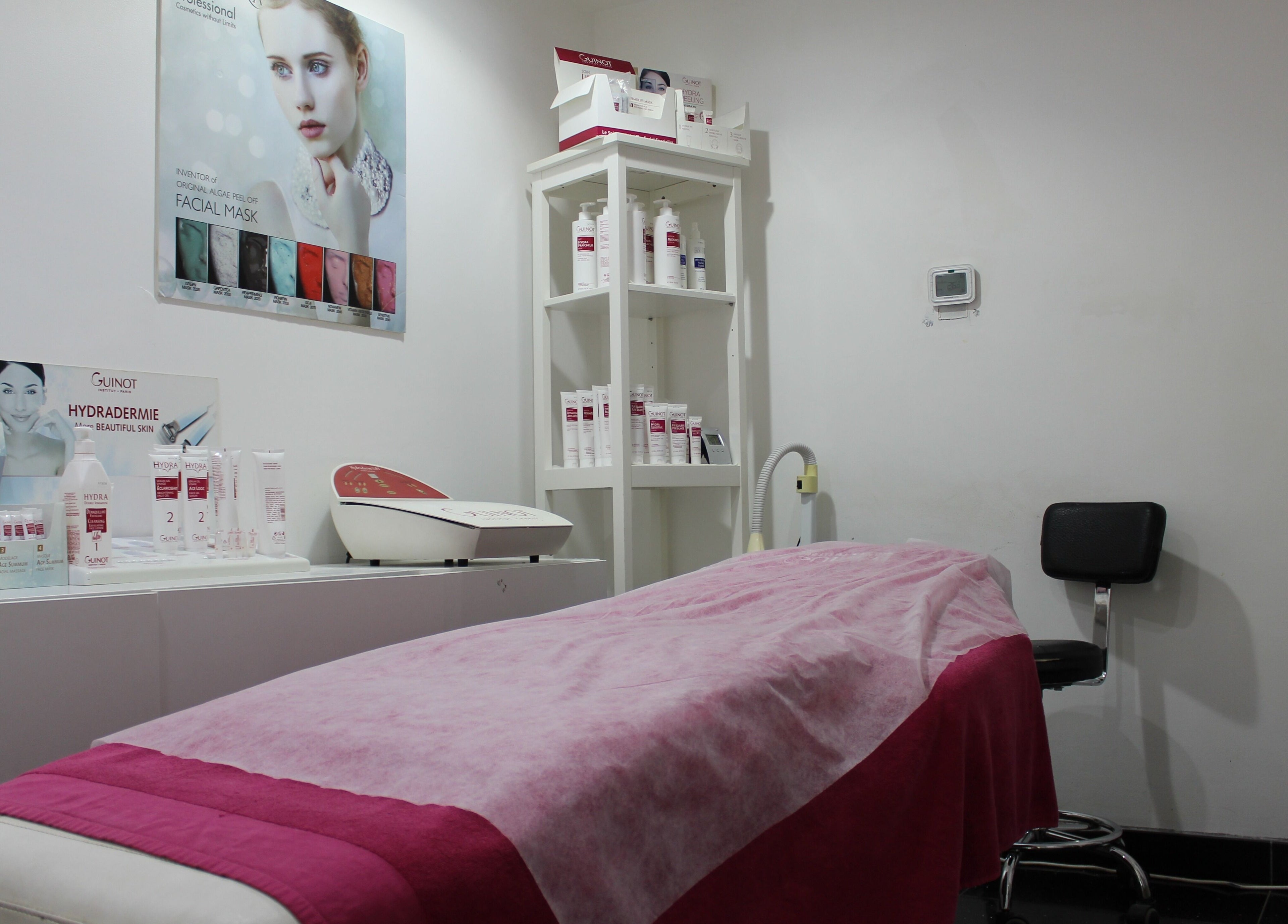 Relaxing treatment room at Black & White Salon, Dubai, Dubai, AE, featuring skincare products and cozy bed.