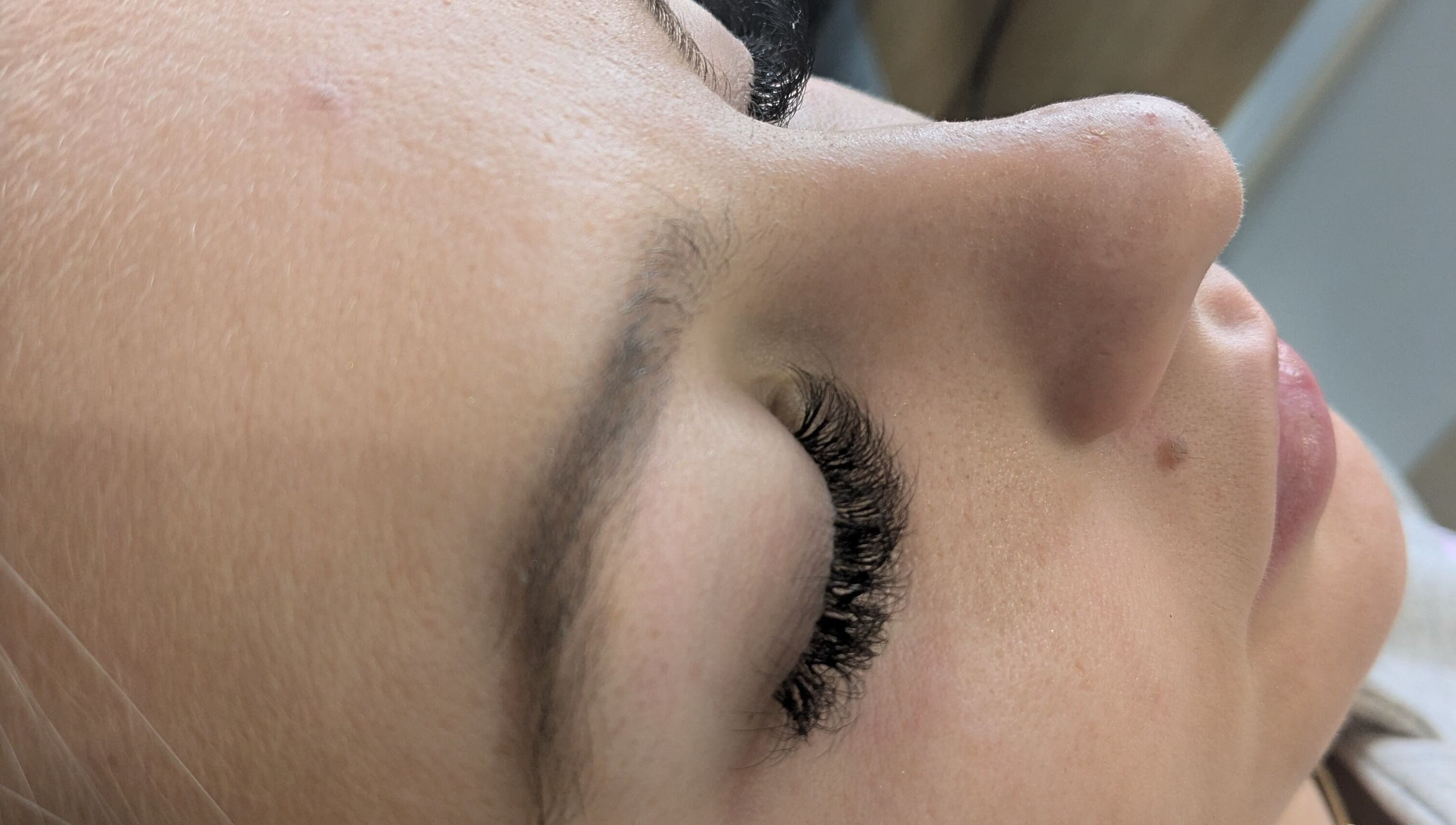 Close-up of a woman receiving eyelash extensions at Beauty by Kimberley, Dollar, Scotland, GB.
