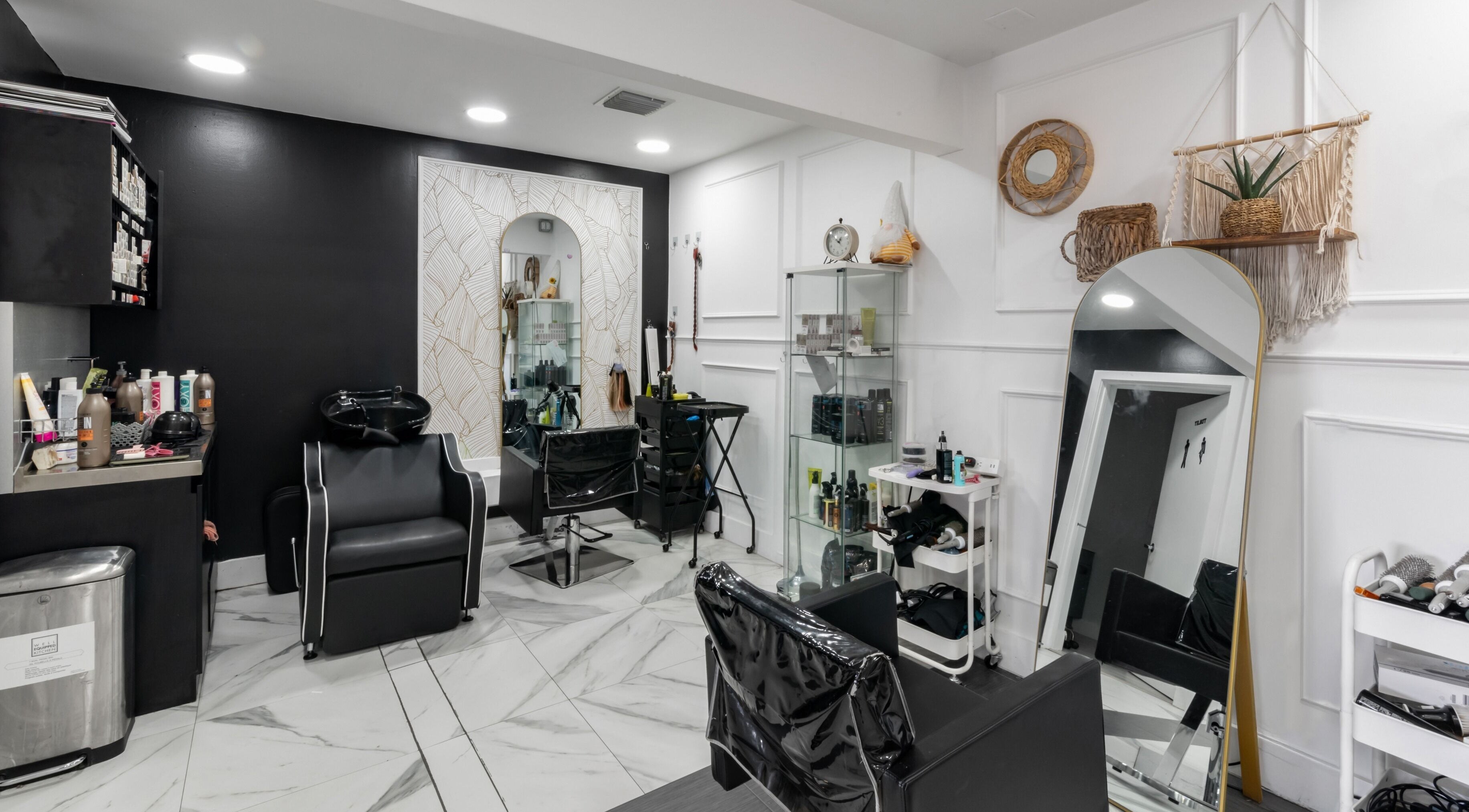 Modern styling area at Q Studio Beauty Bar in Doral, Florida, US featuring sleek chairs and elegant decor.