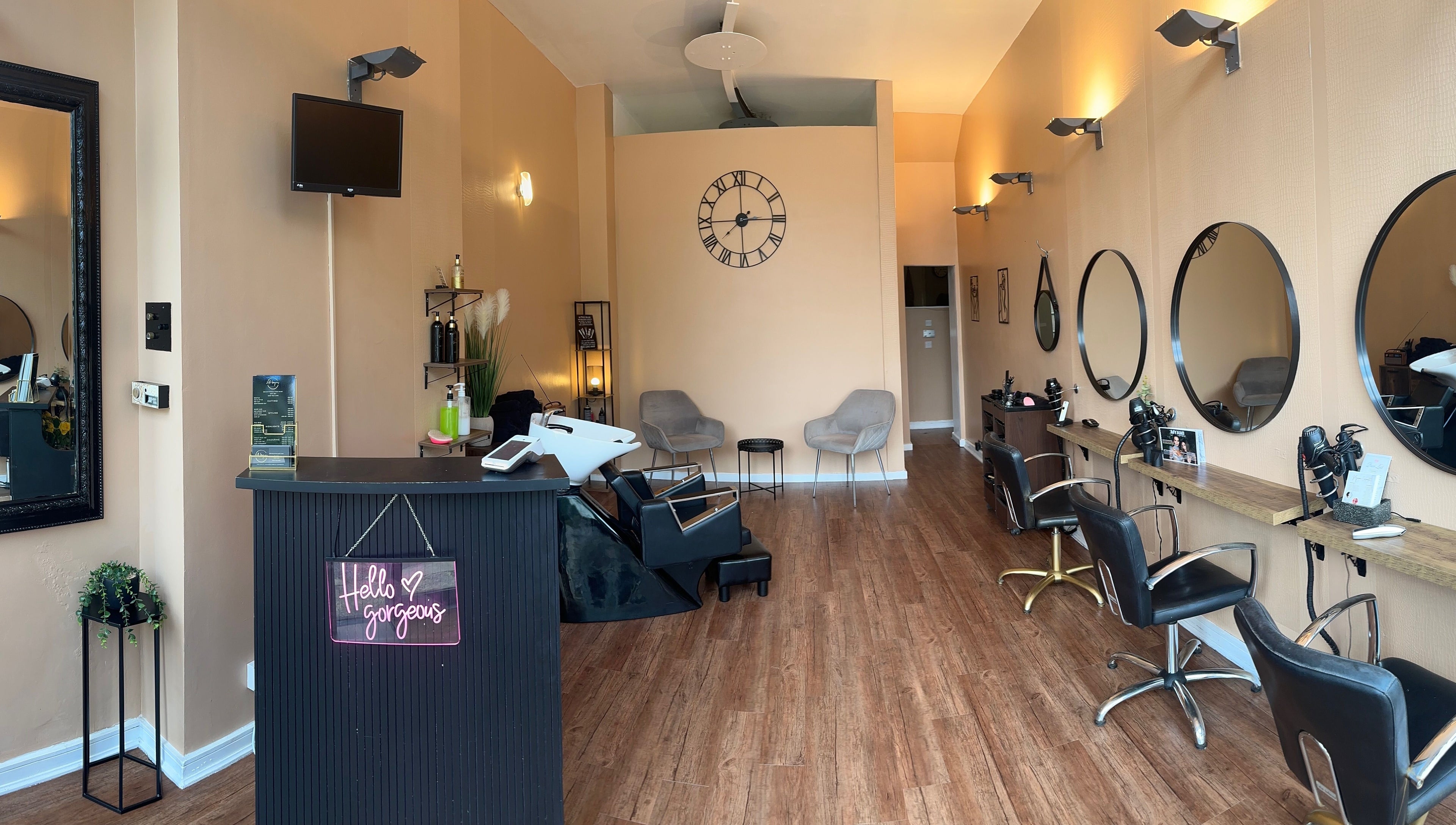 Interior of Hello Gorgeous Hairdressing in London, England, GB, showcasing stylish salon stations and chic decor.