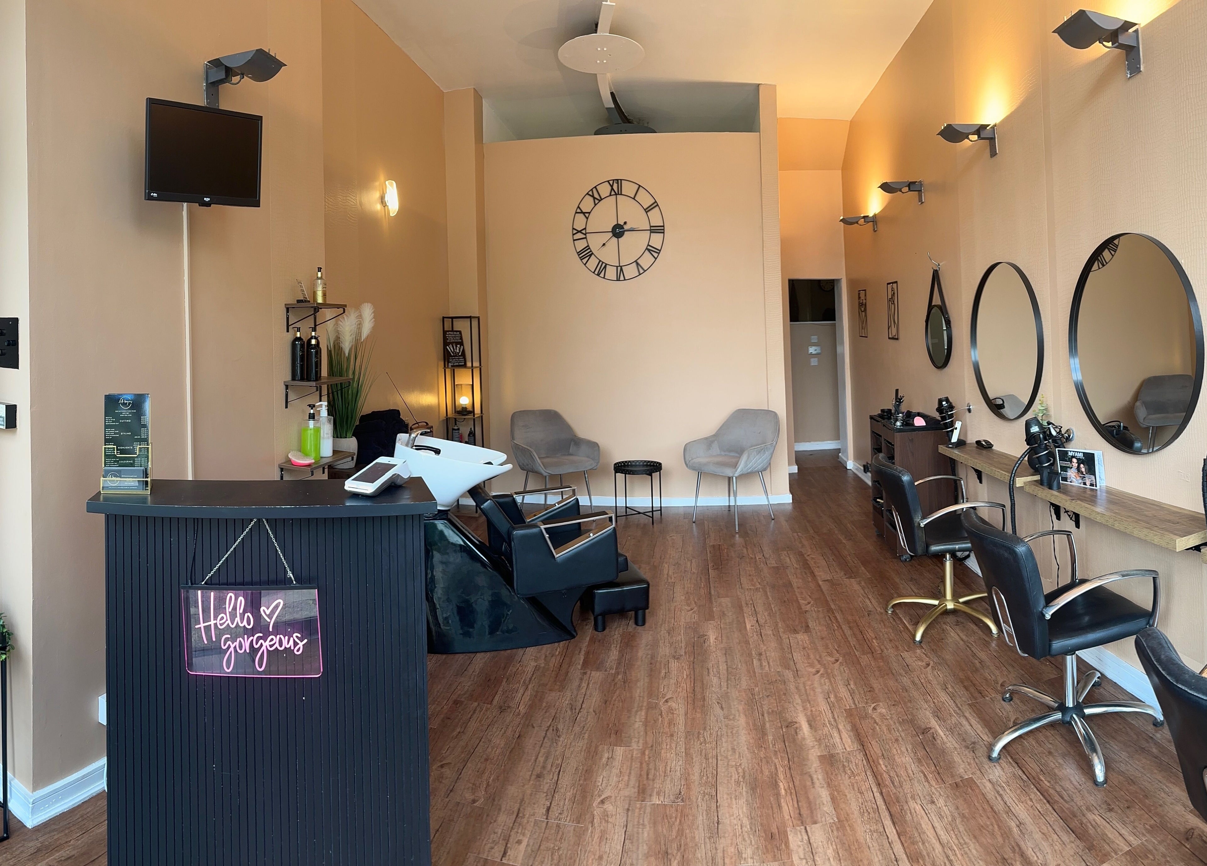 Interior of Hello Gorgeous Hairdressing in London, England, GB, showcasing stylish salon stations and chic decor.