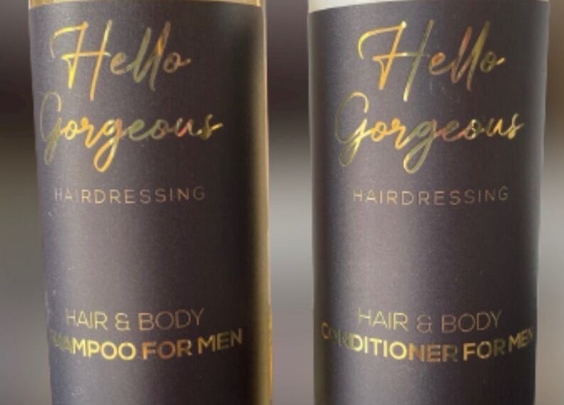 Men's hair products from Hello Gorgeous Hairdressing, London, England, GB. Sleek black bottles with gold text.