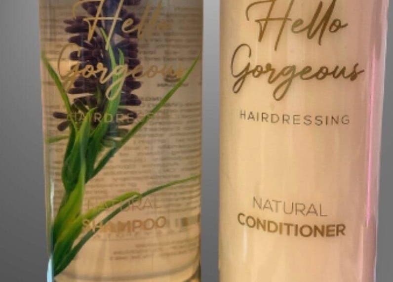 Hello Gorgeous Hairdressing shampoo and conditioner bottles at London, England, GB, offering premium hair care.