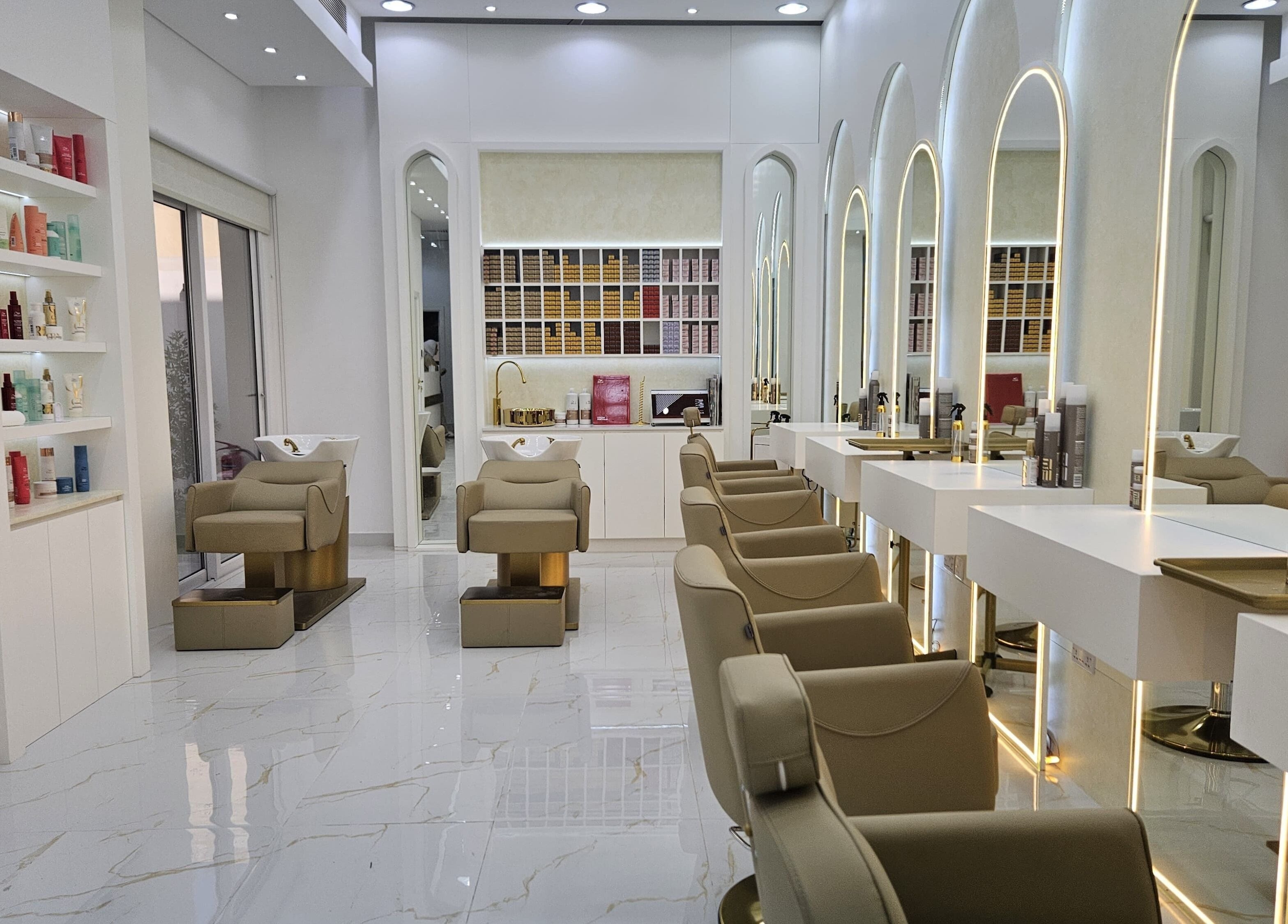 Modern interior of Azalea Beauty Center in Sharjah, Sharjah, AE featuring stylish salon chairs and mirrors.