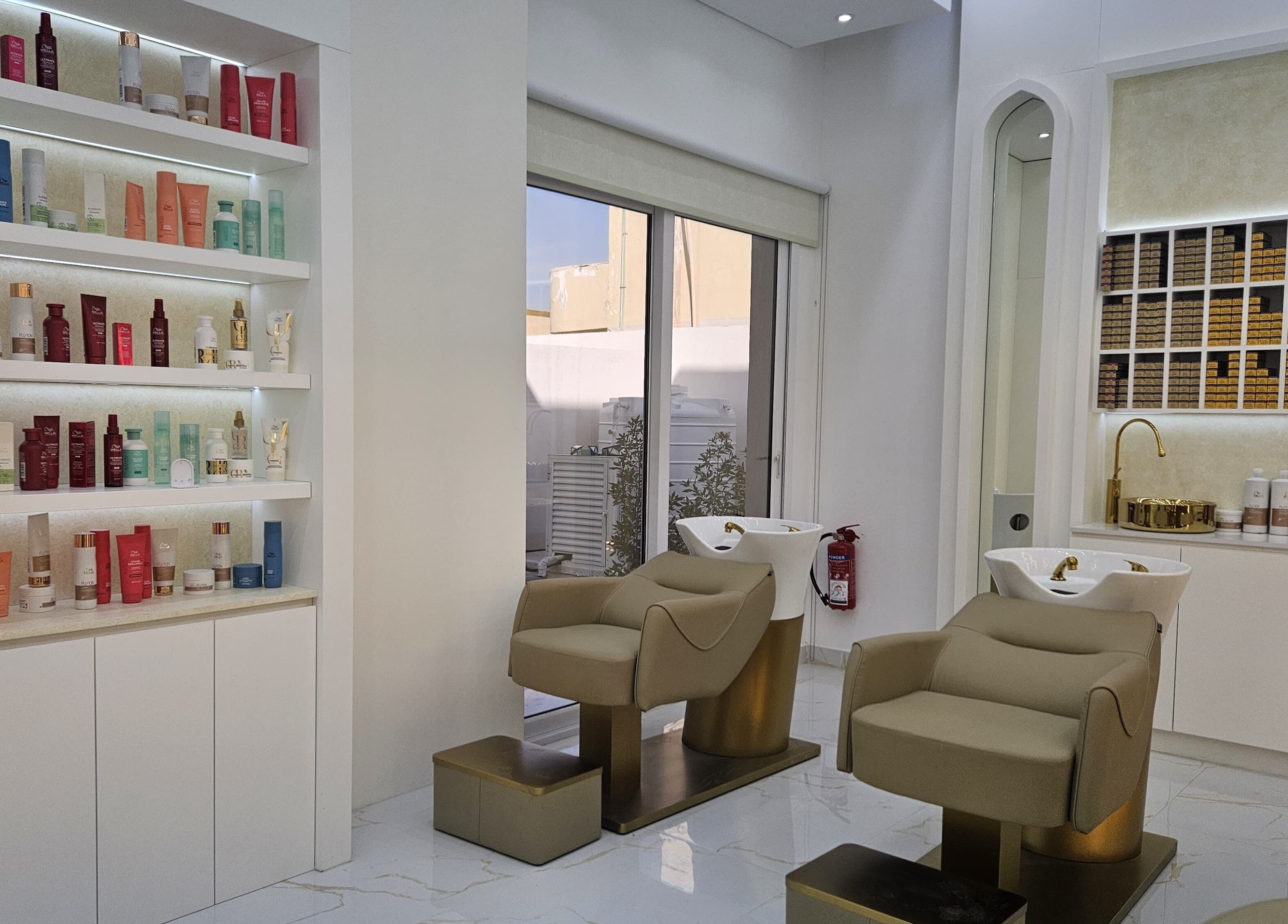 Modern salon interior at Azalea Beauty Center, Sharjah, Sharjah, AE showcasing stylist chairs and product display.
