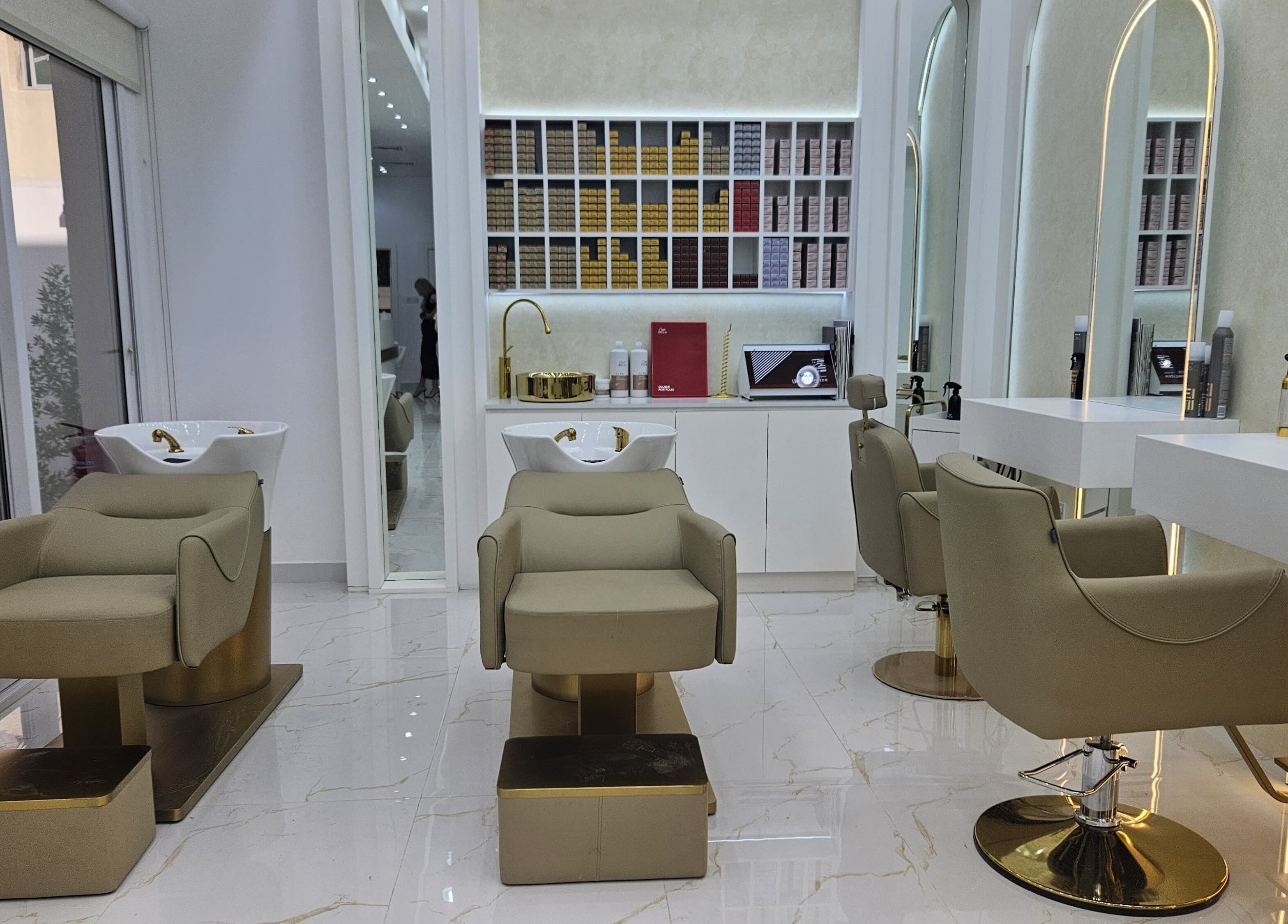 Modern salon interior at Azalea Beauty Center, Sharjah, Sharjah, AE featuring chic styling chairs and mirrors.