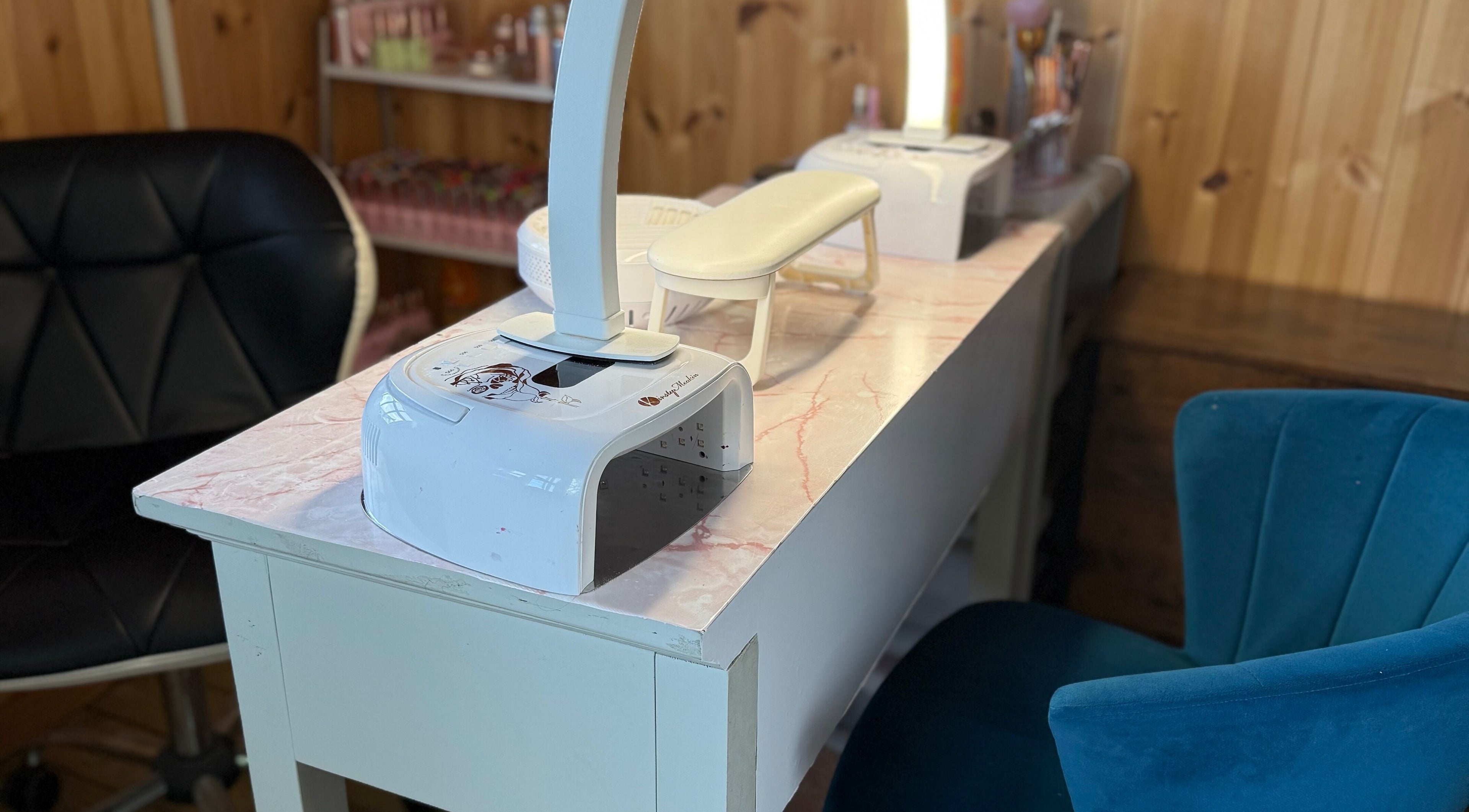 Modern nail station at Ultimate Sass Nails, East Leake, England, GB, featuring plush seating.