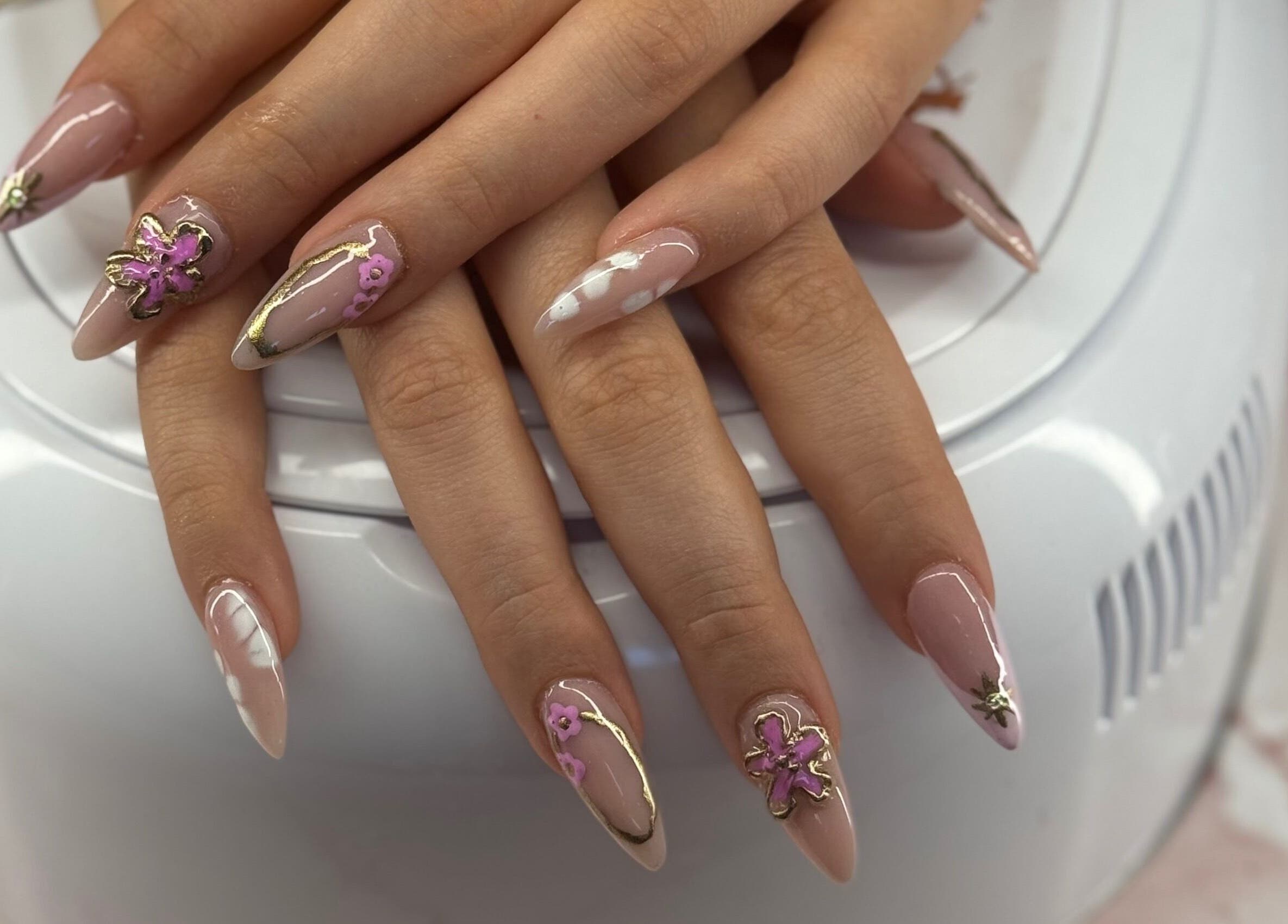 Sophisticated floral nail art at Ultimate Sass Nails, East Leake, England, GB showcasing detailed design.