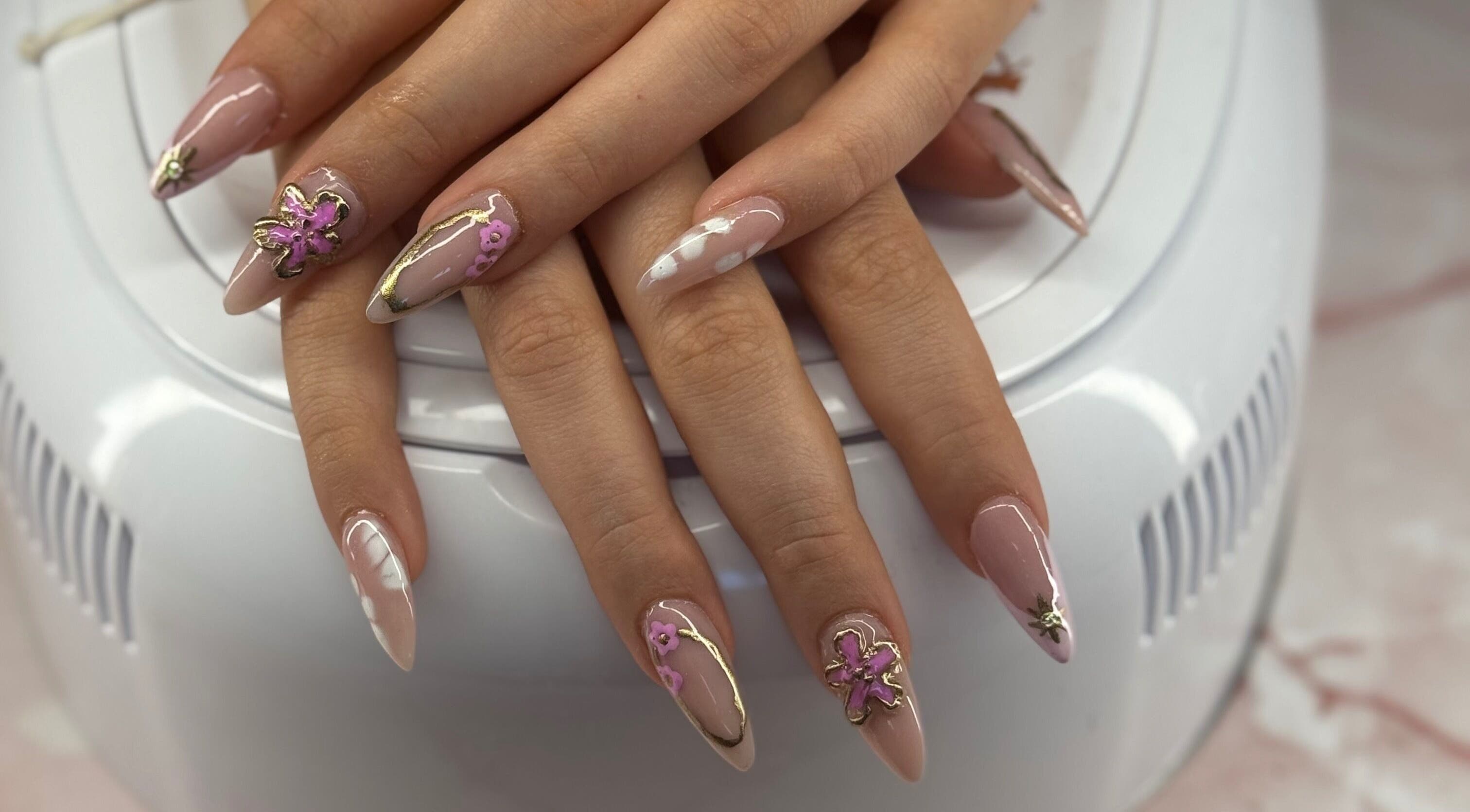 Sophisticated floral nail art at Ultimate Sass Nails, East Leake, England, GB showcasing detailed design.