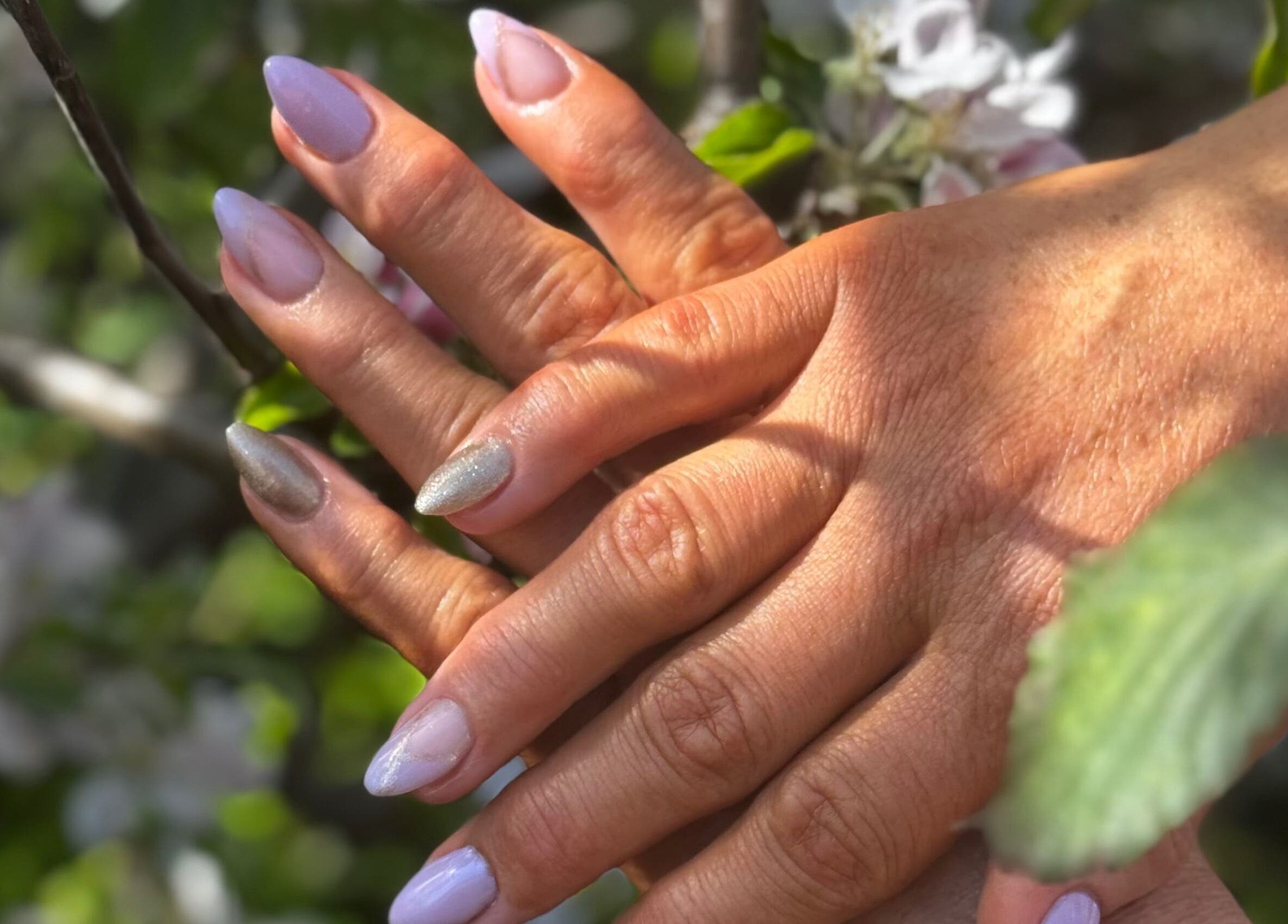 Elegant pastel nails styled at Ultimate Sass Nails, East Leake, England, GB, amid lush greenery.