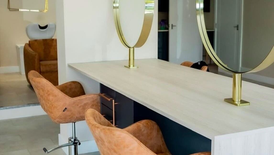 Modern salon chairs and mirrors at Stephanie Smith Hair in Aylesbury, England, GB.