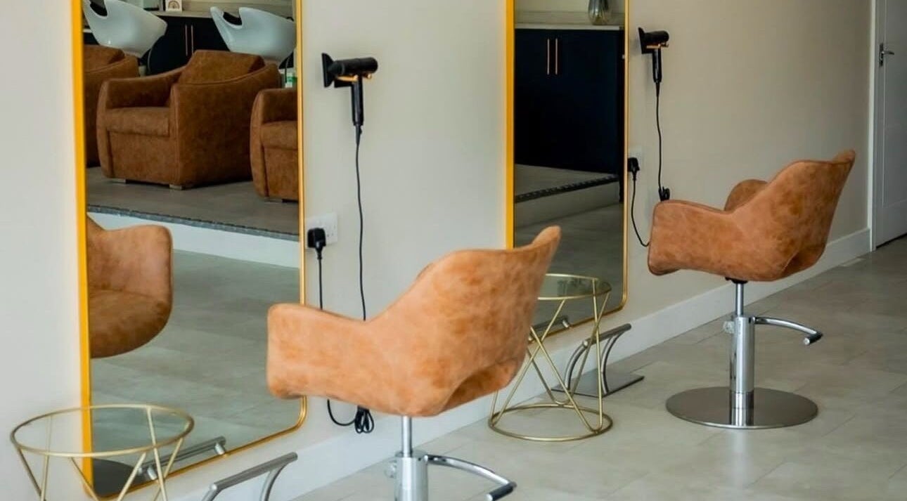 Modern salon interior with stylish chairs and mirrors at Stephanie Smith Hair, Aylesbury, England, GB.