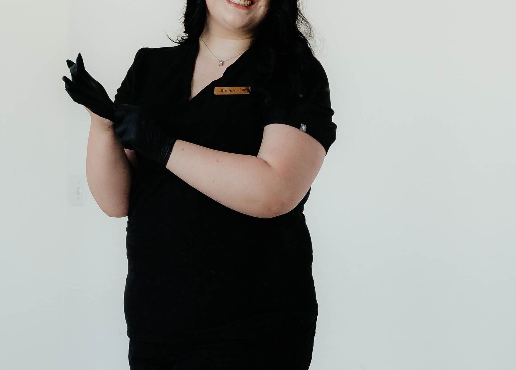 Professional at Your Esti Katie Utah in South Jordan, Utah, US, wearing black gloves and smiling.