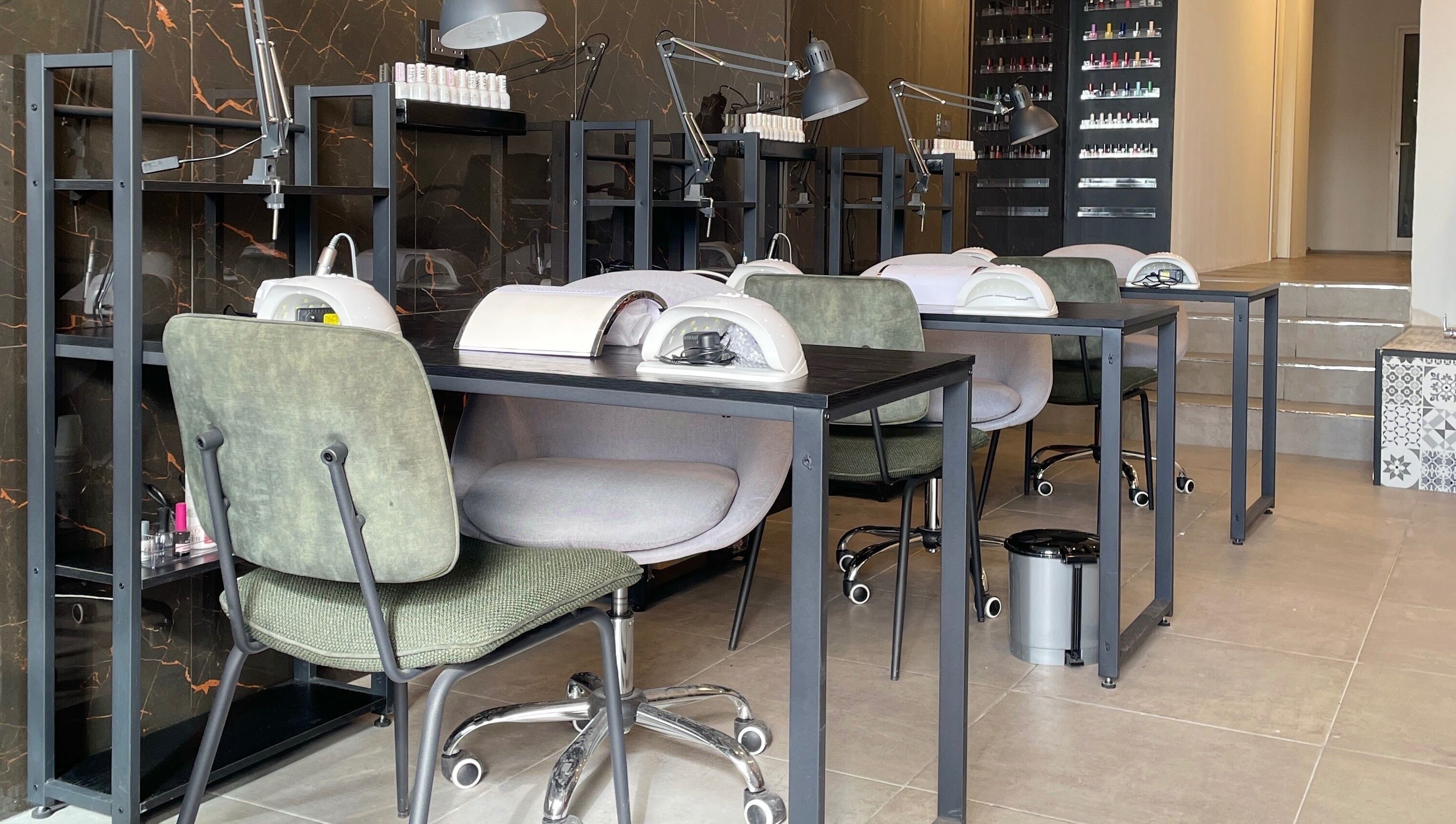 Modern nail salon setup at Diva Beauty Lounge, Tas-sliema, MT, showcasing manicure stations.