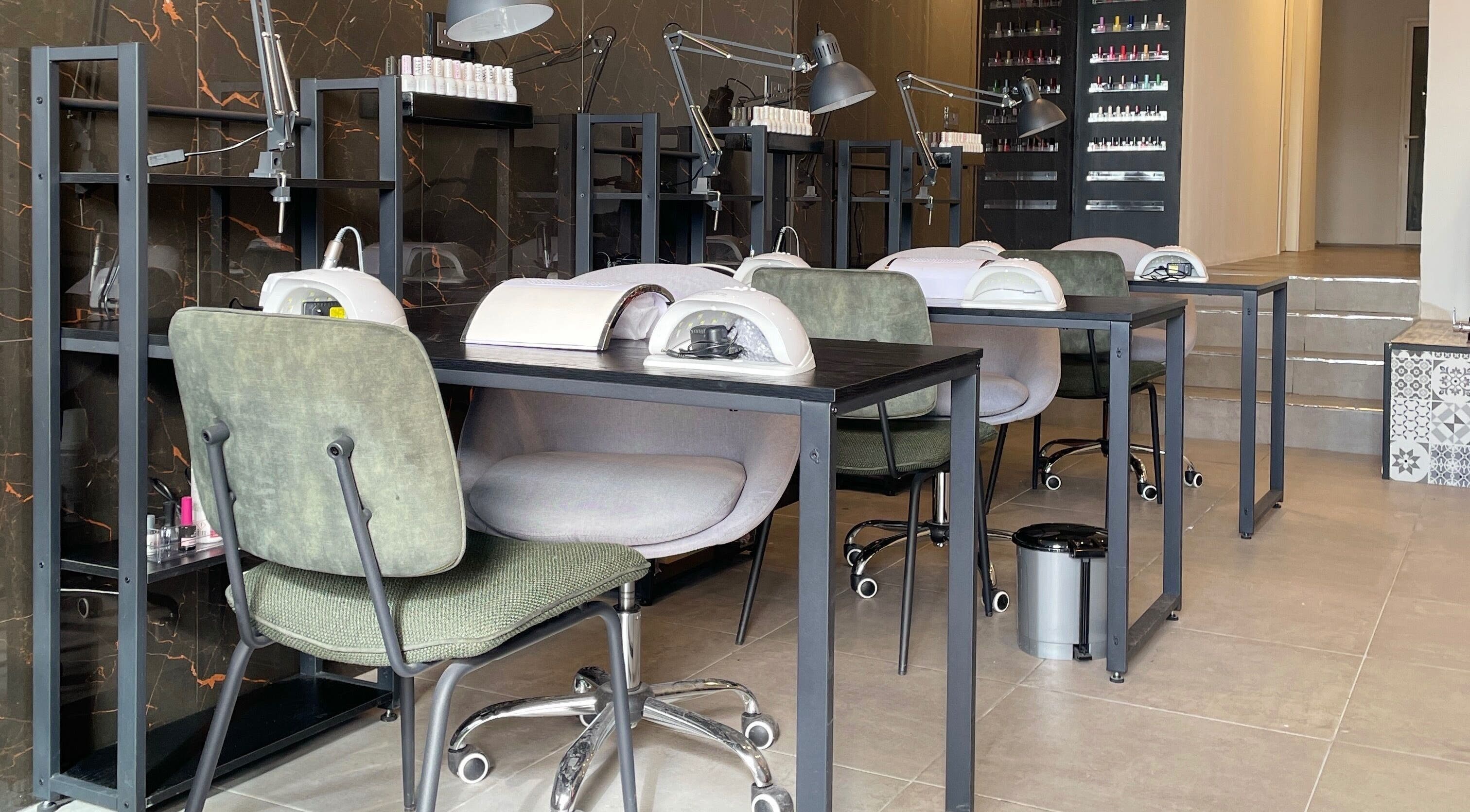 Modern nail salon setup at Diva Beauty Lounge, Tas-sliema, MT, showcasing manicure stations.